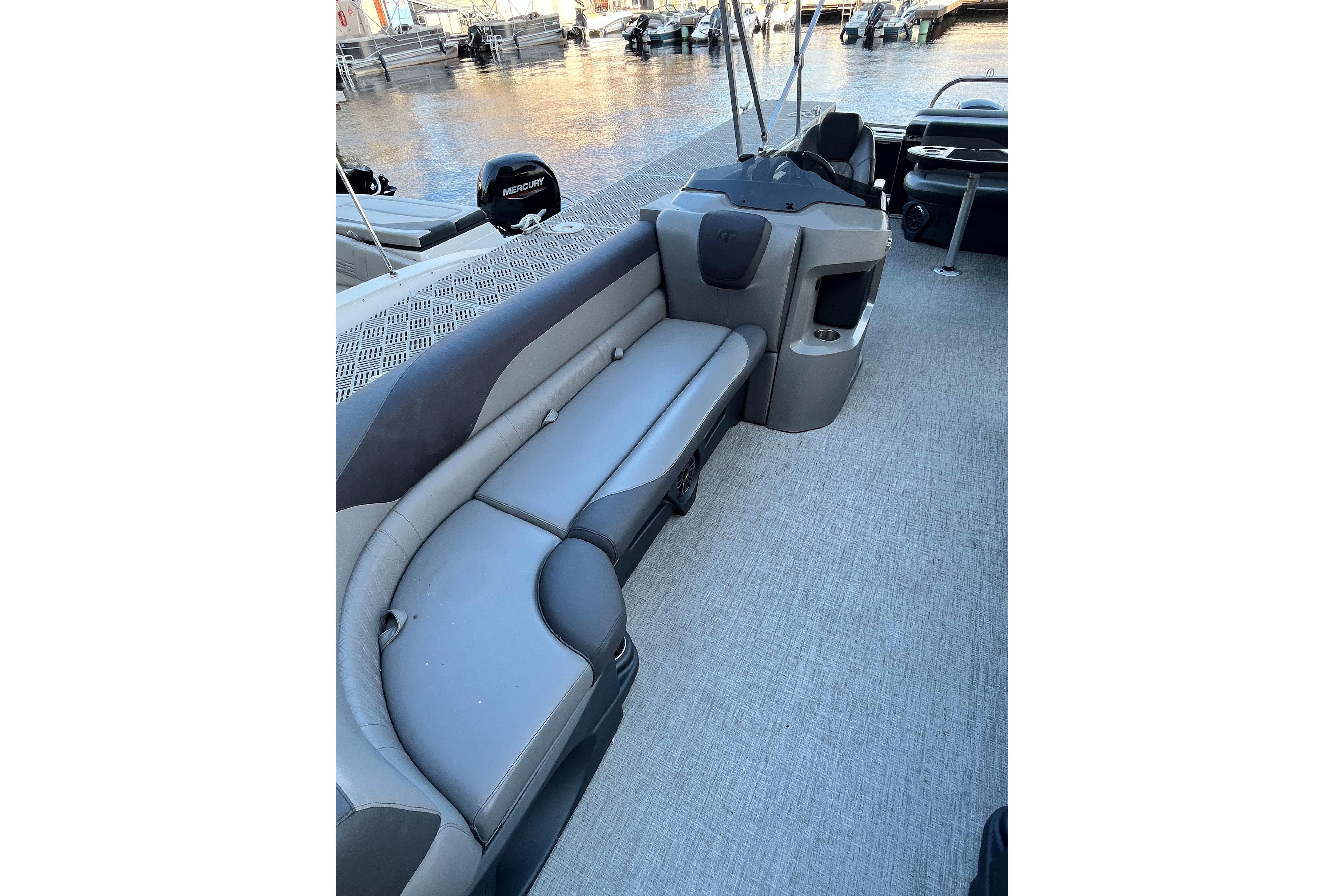 2023 Tahoe Pontoon LTZ Cruise interior with gray seating and water view.