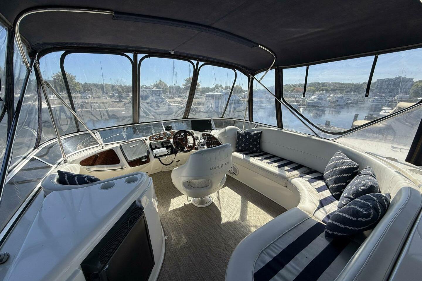 Luxurious 2008 Meridian 459 Motoryacht interior with plush seating and panoramic windows.