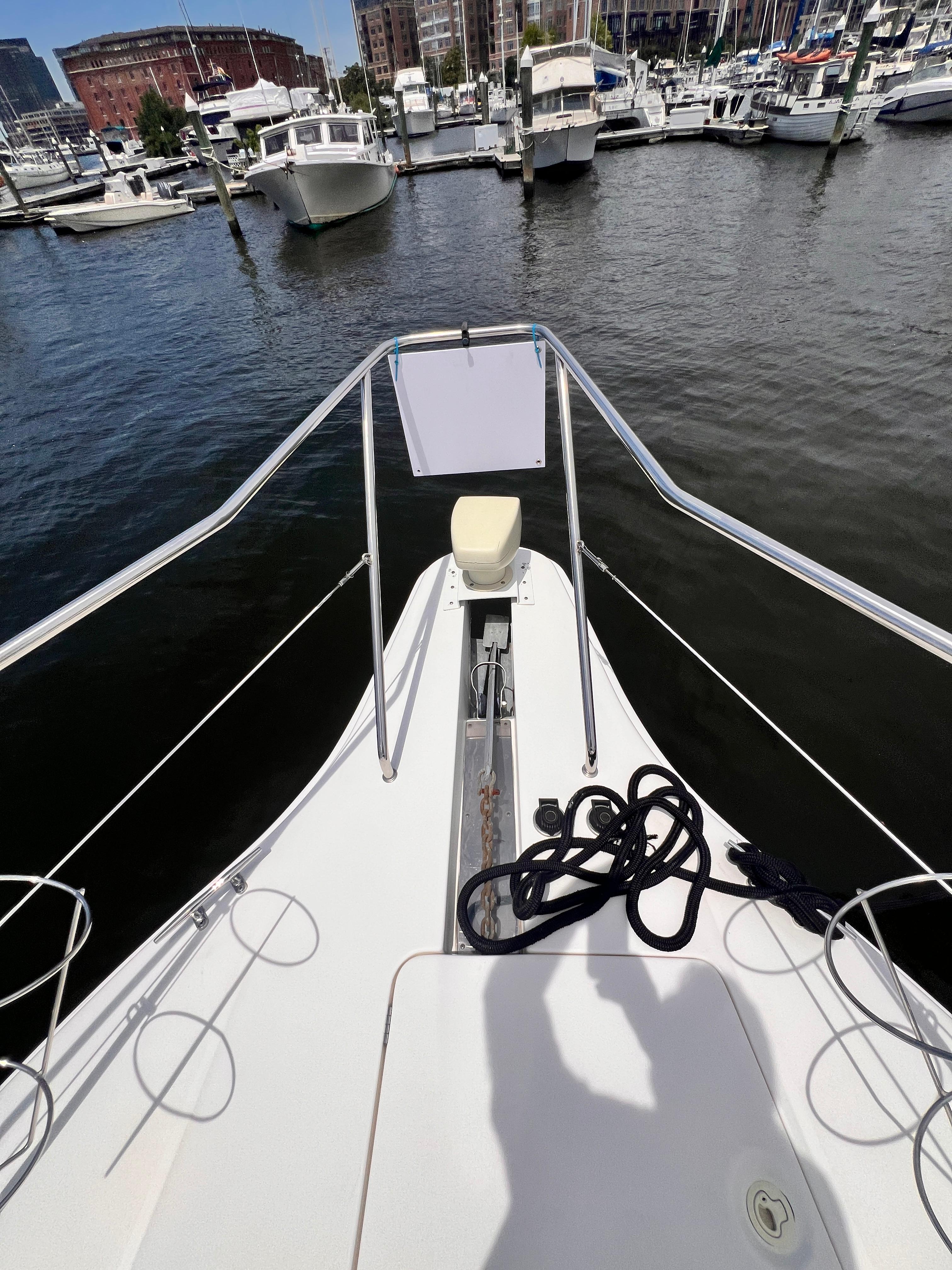 Bow of a 2001 Silverton 352 Motor Yacht docked at a marina.