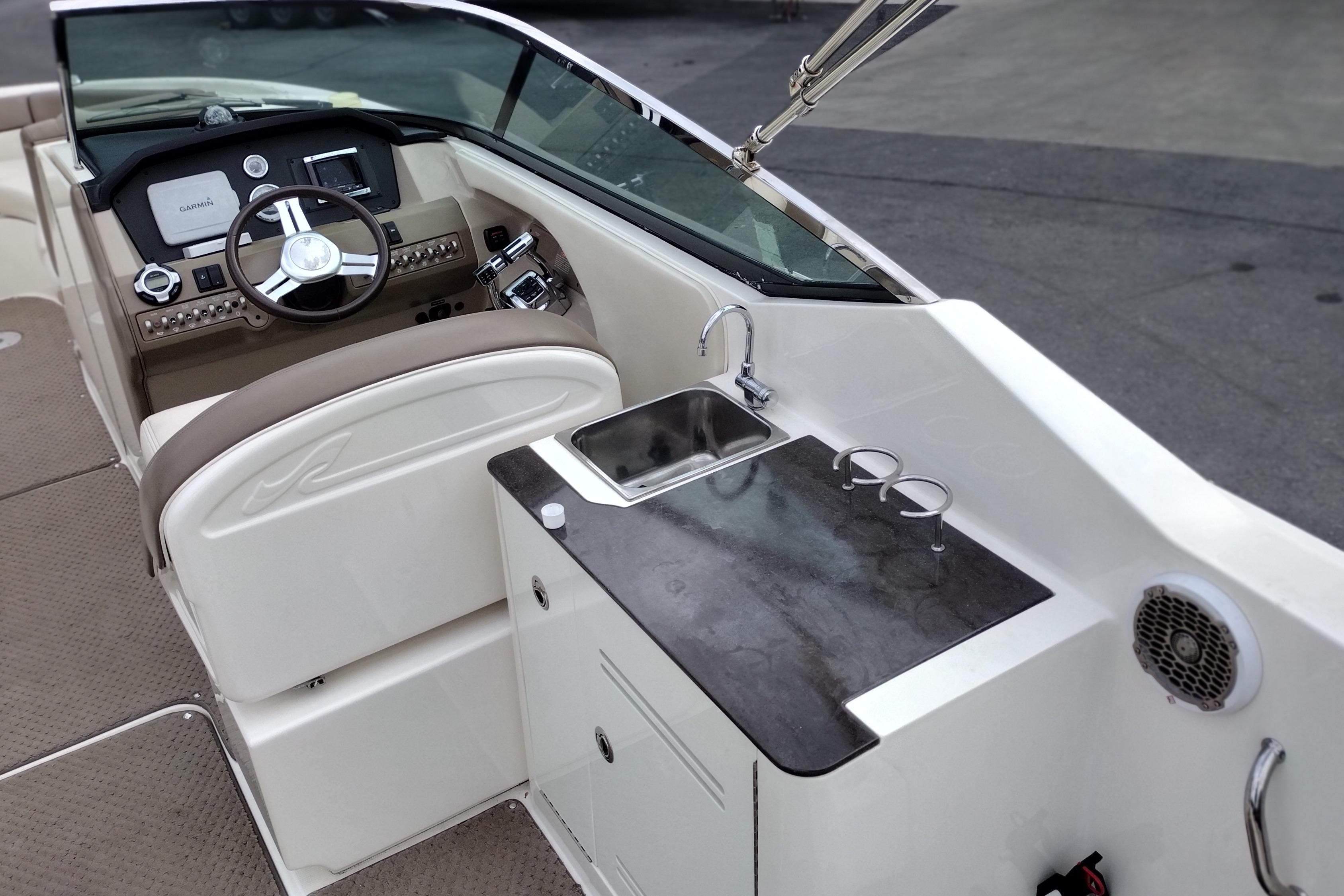 2013 Sea Ray 300 SLX boat interior with helm, sink, and countertop.