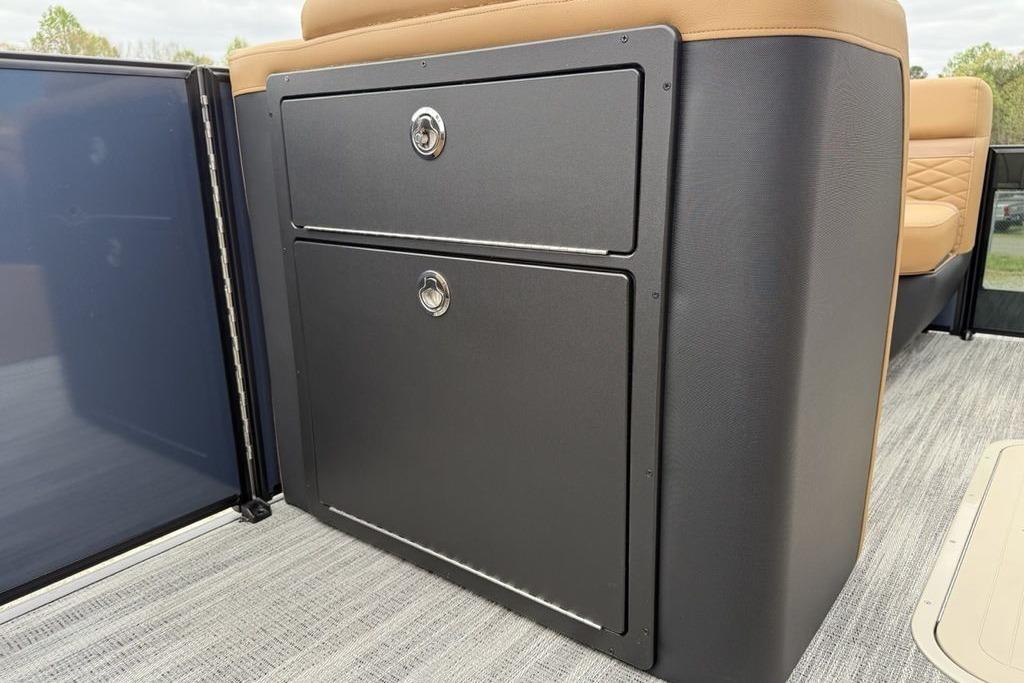 Storage compartment on 2026 Godfrey Monaco 235 SFLC iMPACT boat, featuring sleek design and secure locks.