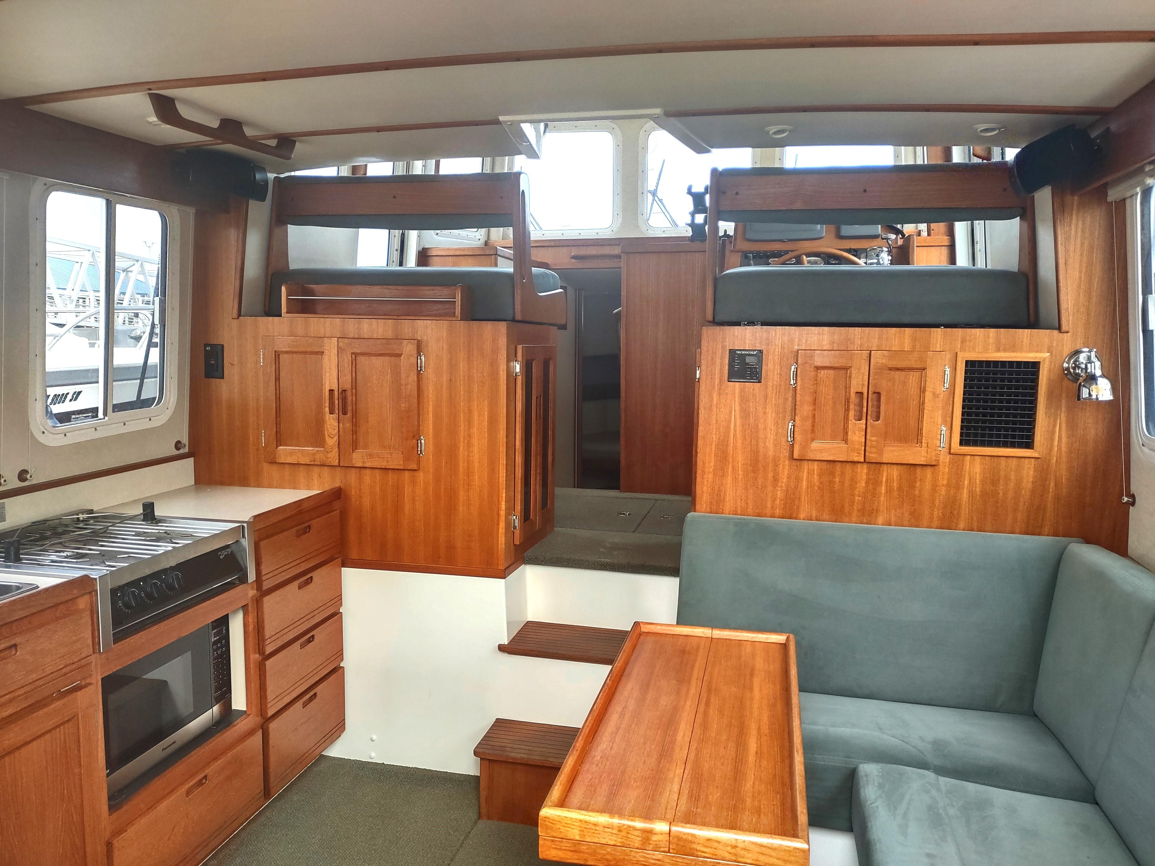 Interior of a 2005 Nordic Tug 32 with wooden furnishings.