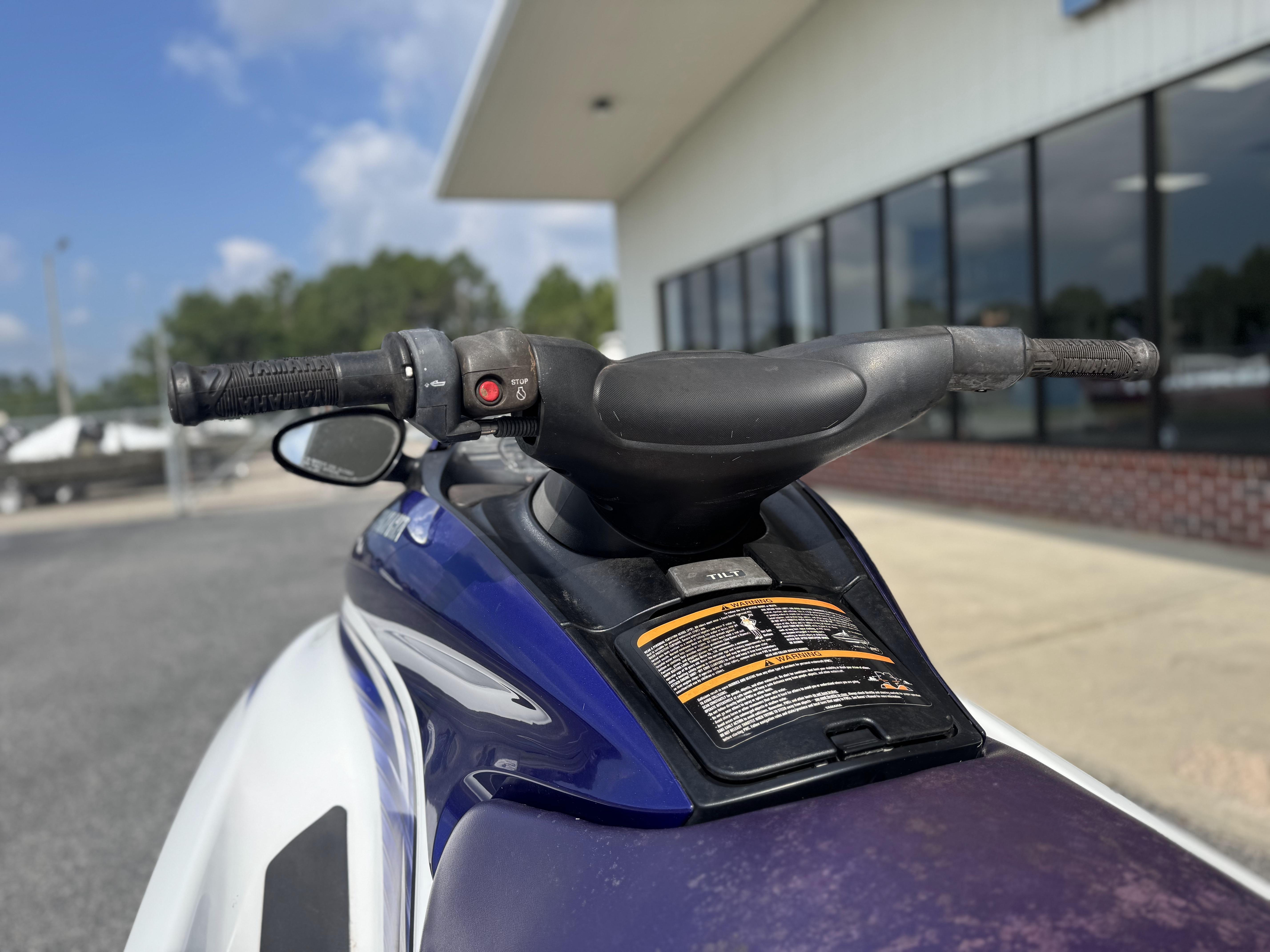 2003 Yamaha WaveRunner FX140 handlebars and controls, parked outdoors near a building.