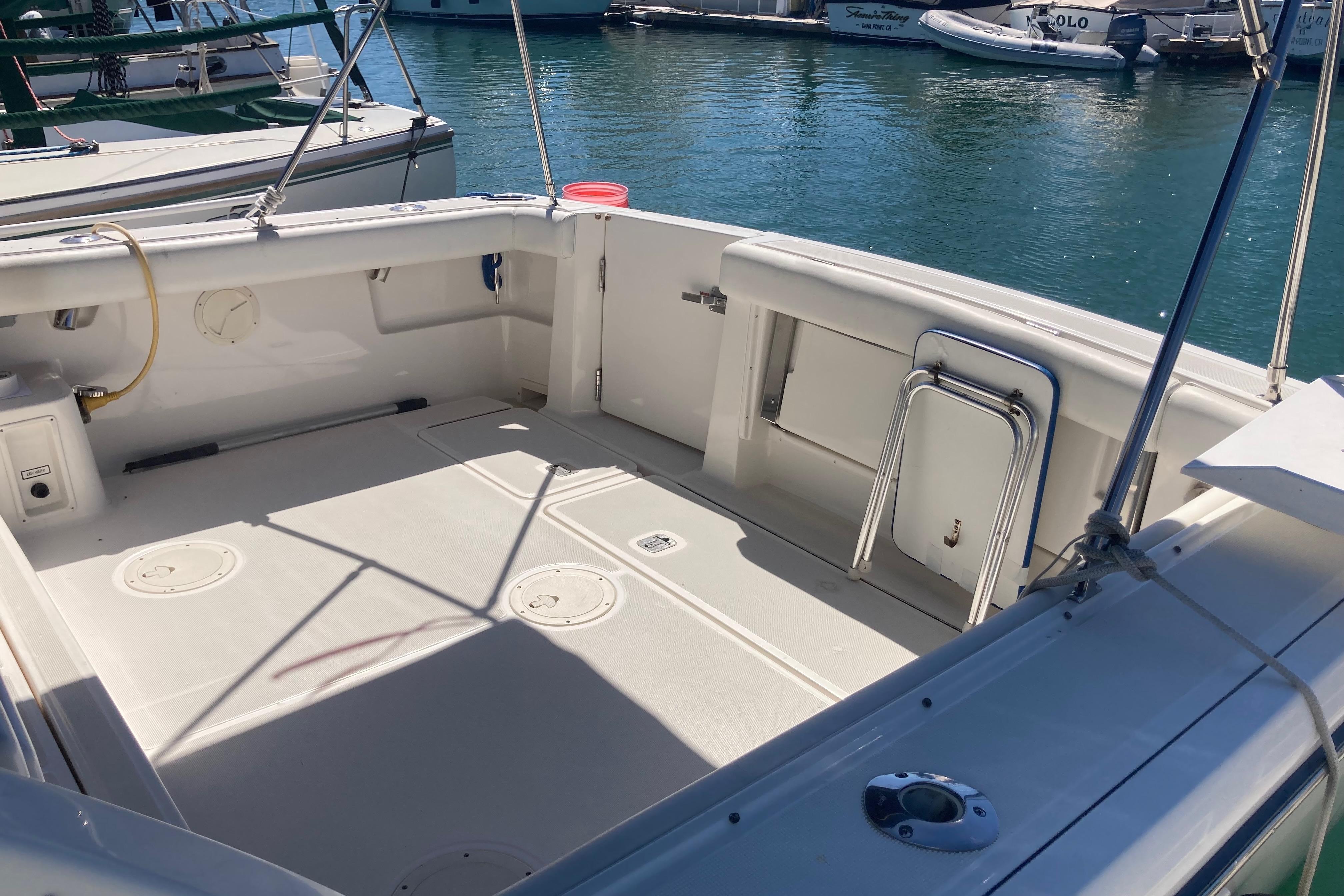 2002 Tiara Yachts 2900 Open boat deck at marina, featuring spacious seating area.