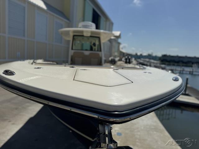 2022 Scout 330 LXF boat docked at a marina, front view.