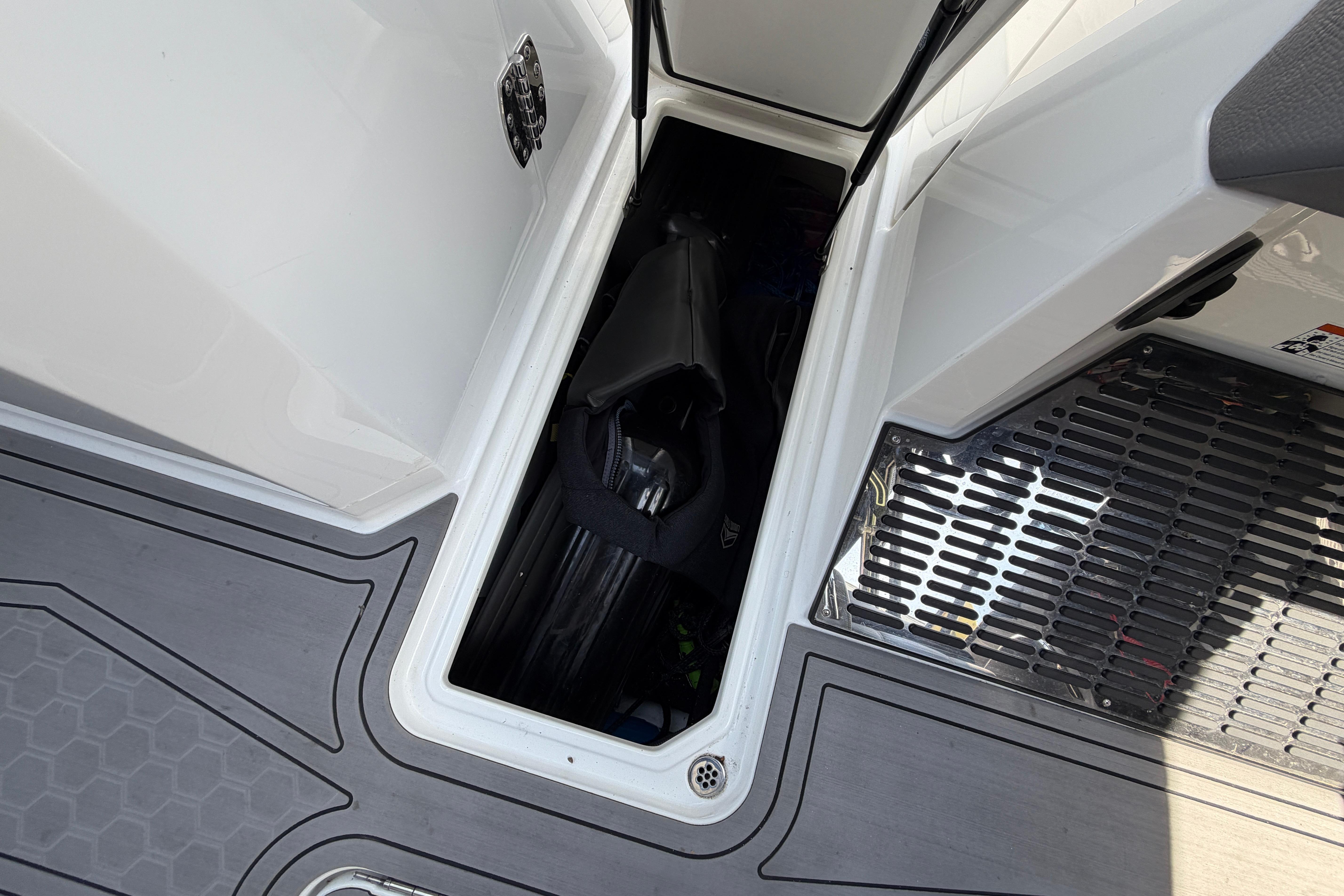 Storage compartment in Cobalt R8 Surf boat with equipment.