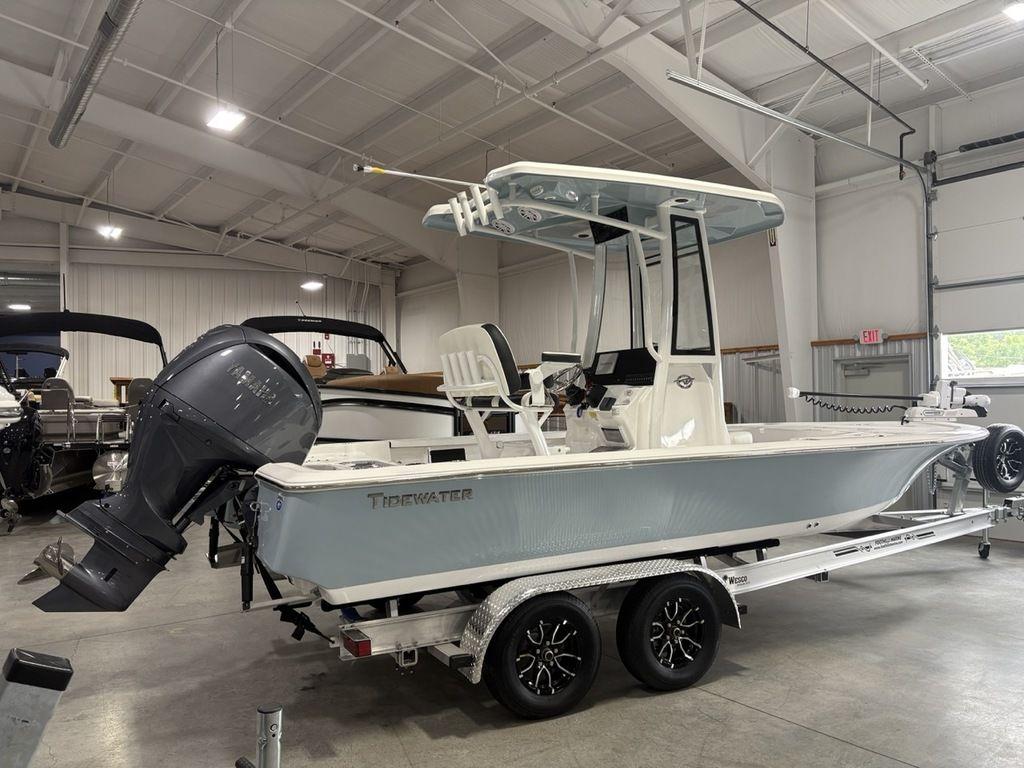 2026 Tidewater 2110 BM boat in showroom, mounted on a trailer, with outboard motor.