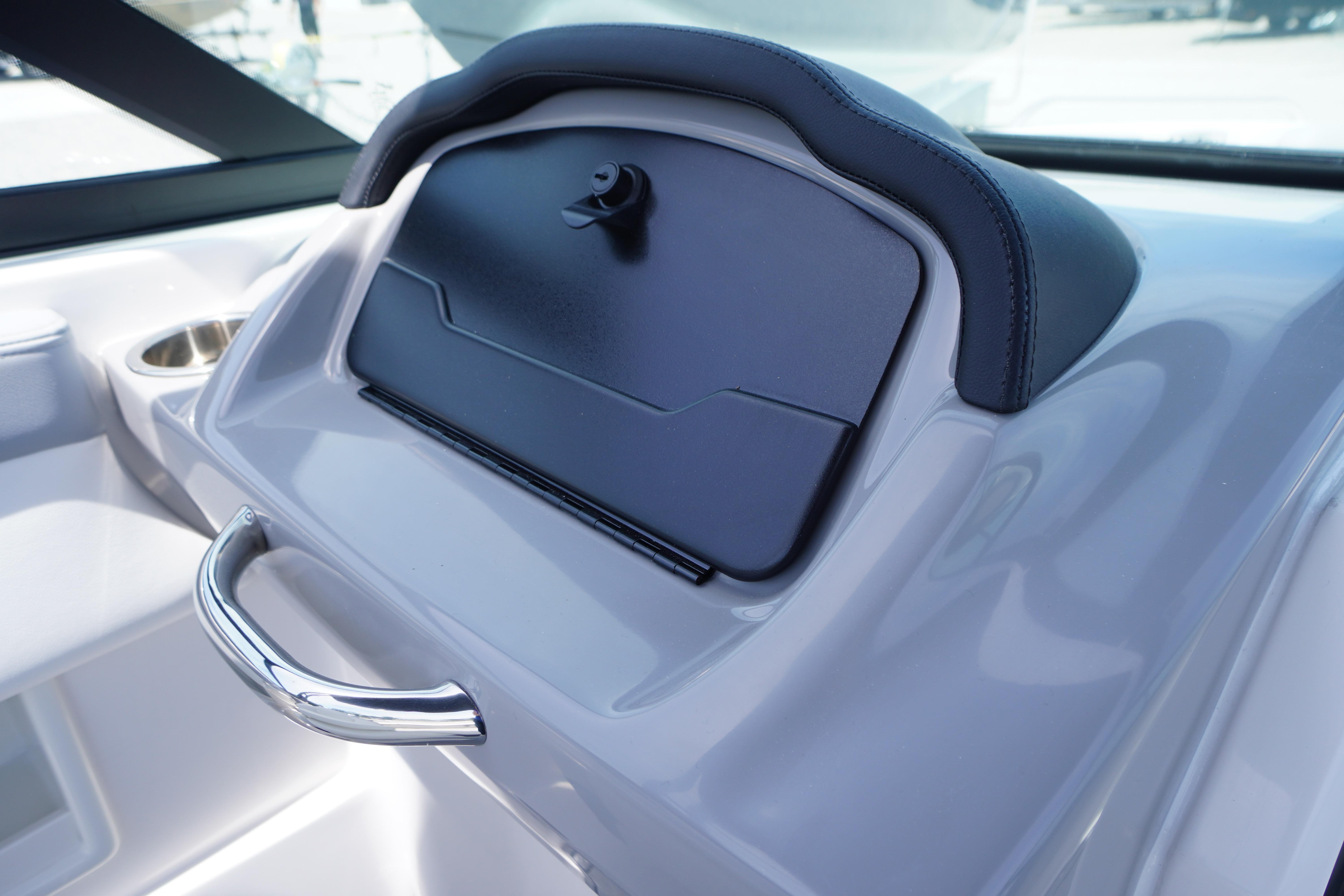 Dashboard of 2026 Chaparral 23 SSi OB boat with storage compartment and handle.
