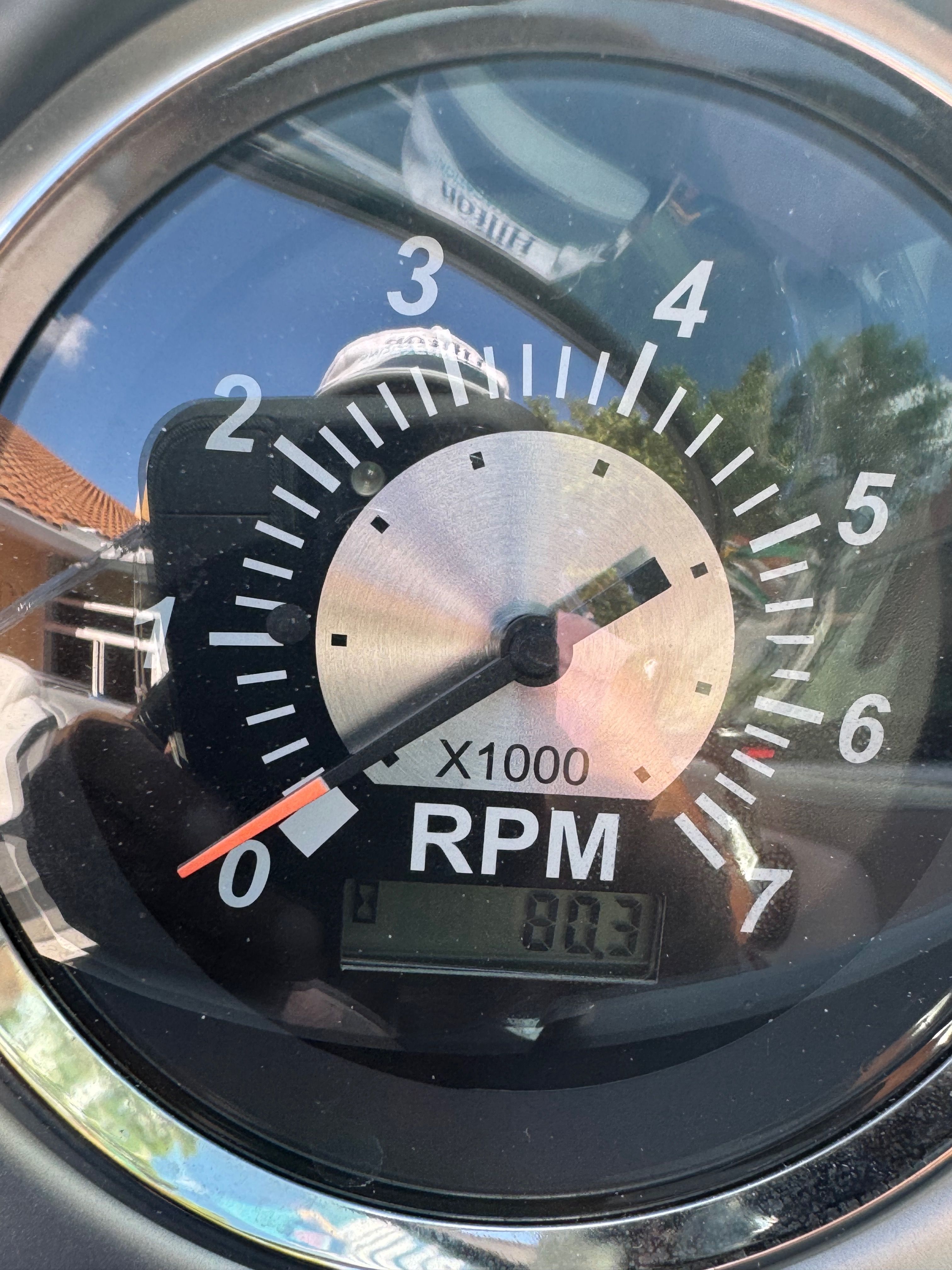 A tachometer displays 803 RPM. The dial is black with white markings.