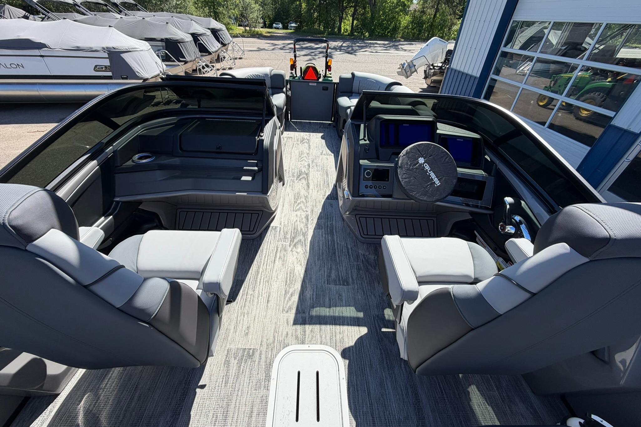 Interior of 2026 Avalon Excalibur LTD Quad Lounge Windshield boat, featuring luxurious seating and modern controls.