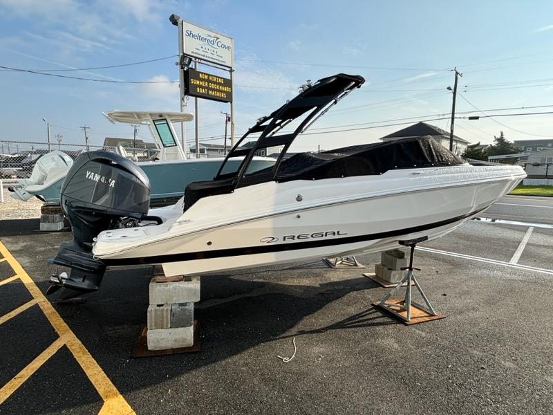 2026 Regal 21 OBX boat with Yamaha outboard engine on display at a marina.