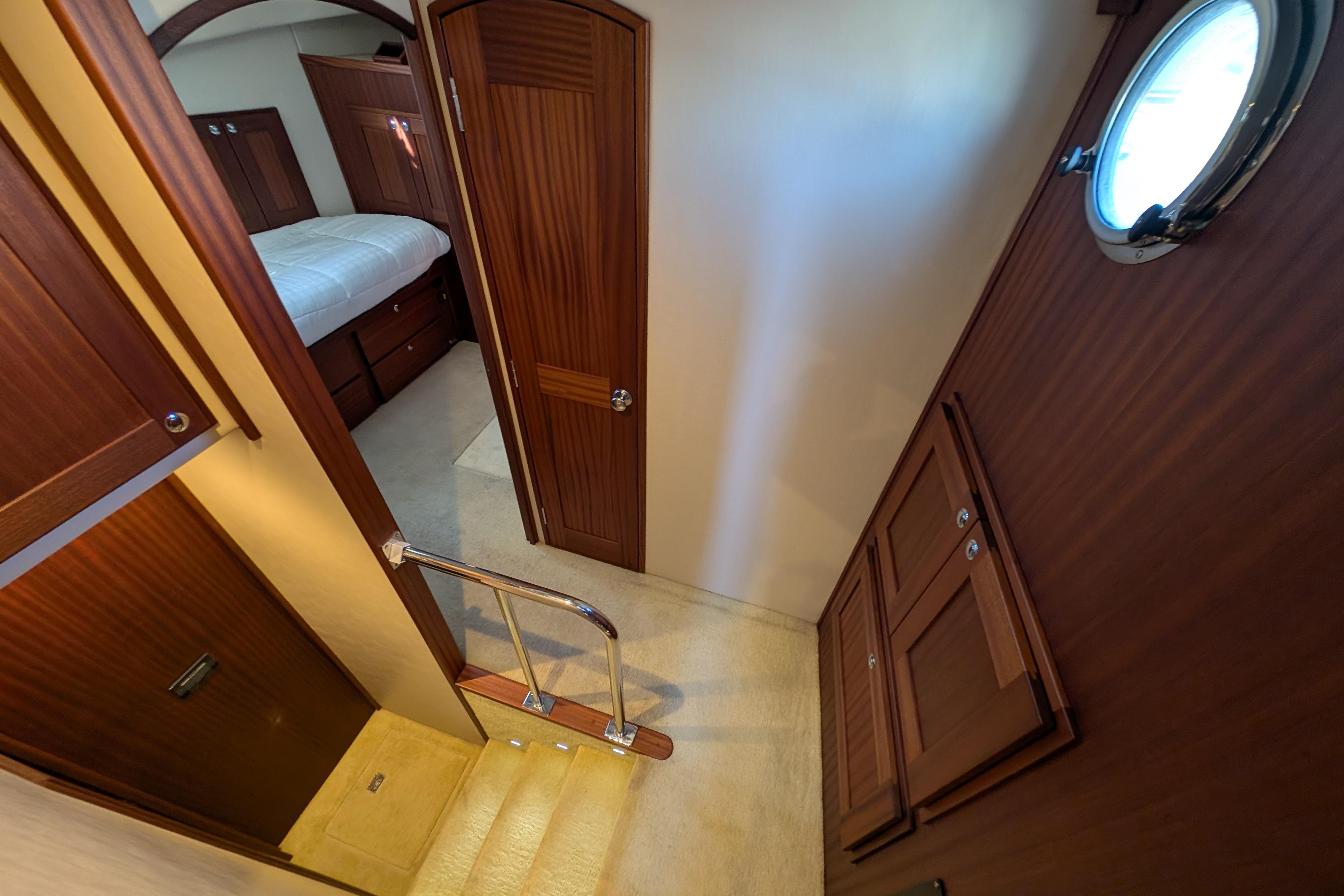 Interior of 2015 American Tug 435, featuring wood paneling and a cozy bedroom.