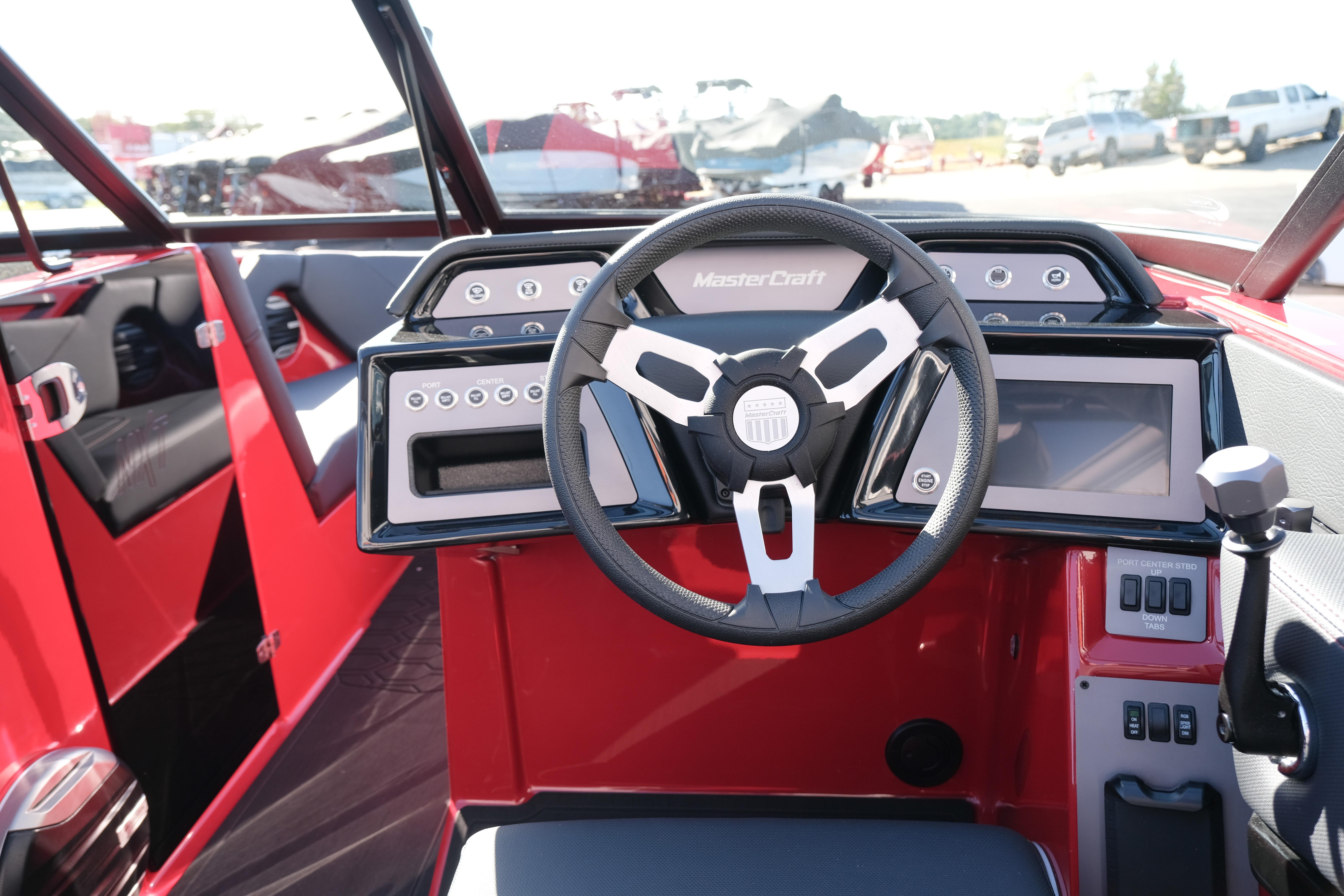 2026 MasterCraft NXT22 boat dashboard with modern steering wheel and digital controls.