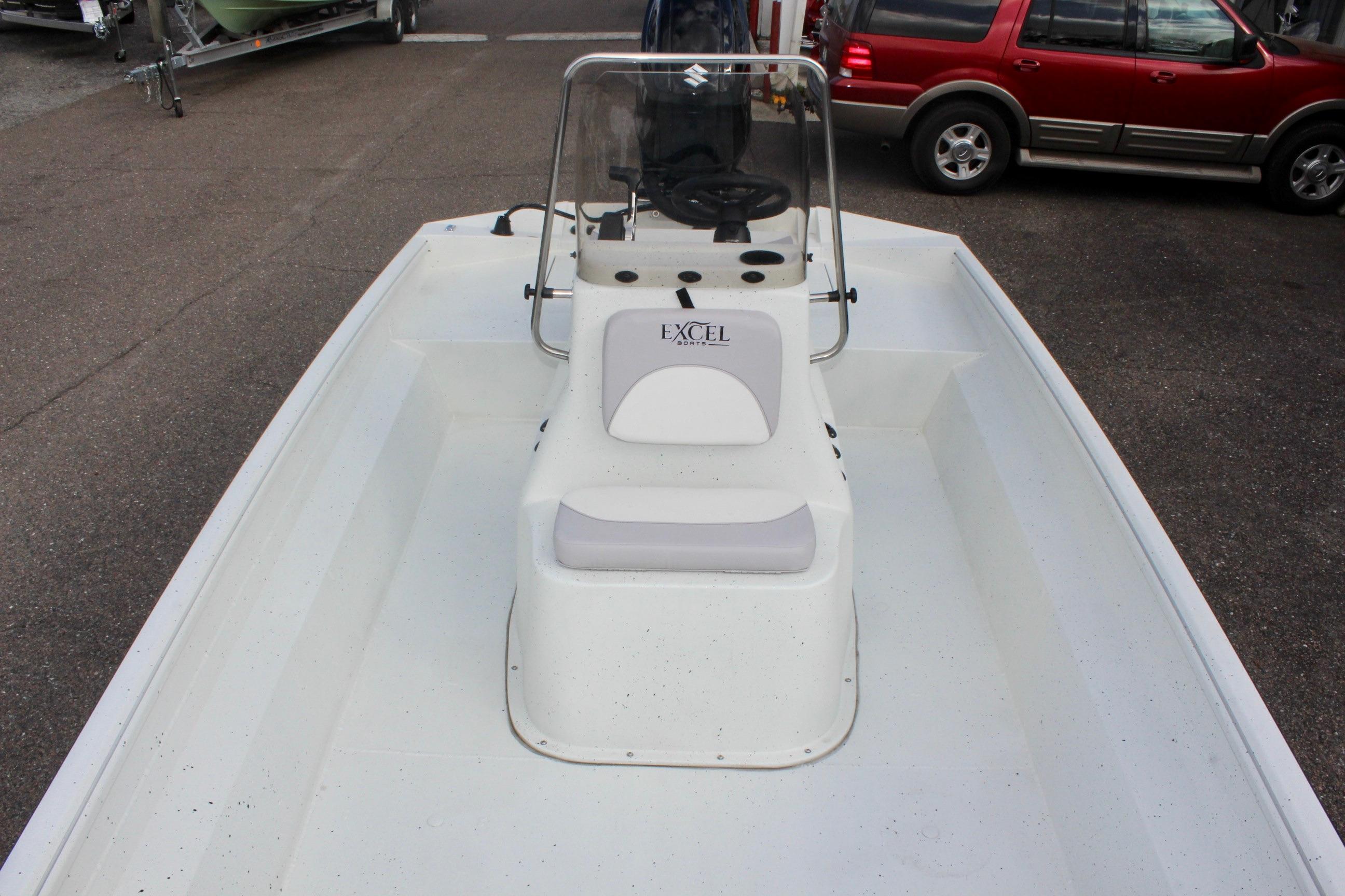 2025 Excel 2172 Stalker CC boat with center console and seating, parked on pavement.