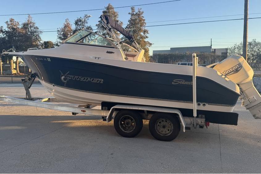 2006 Seaswirl Striper 2101 Dual Console OB on trailer, side view.