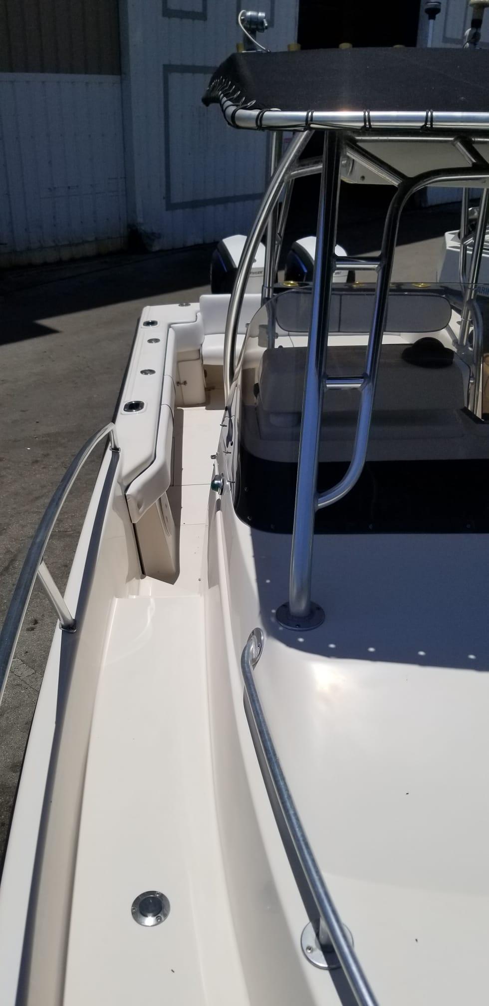 1993 Intrepid 26 Walkaround boat with stainless steel railings and canopy.