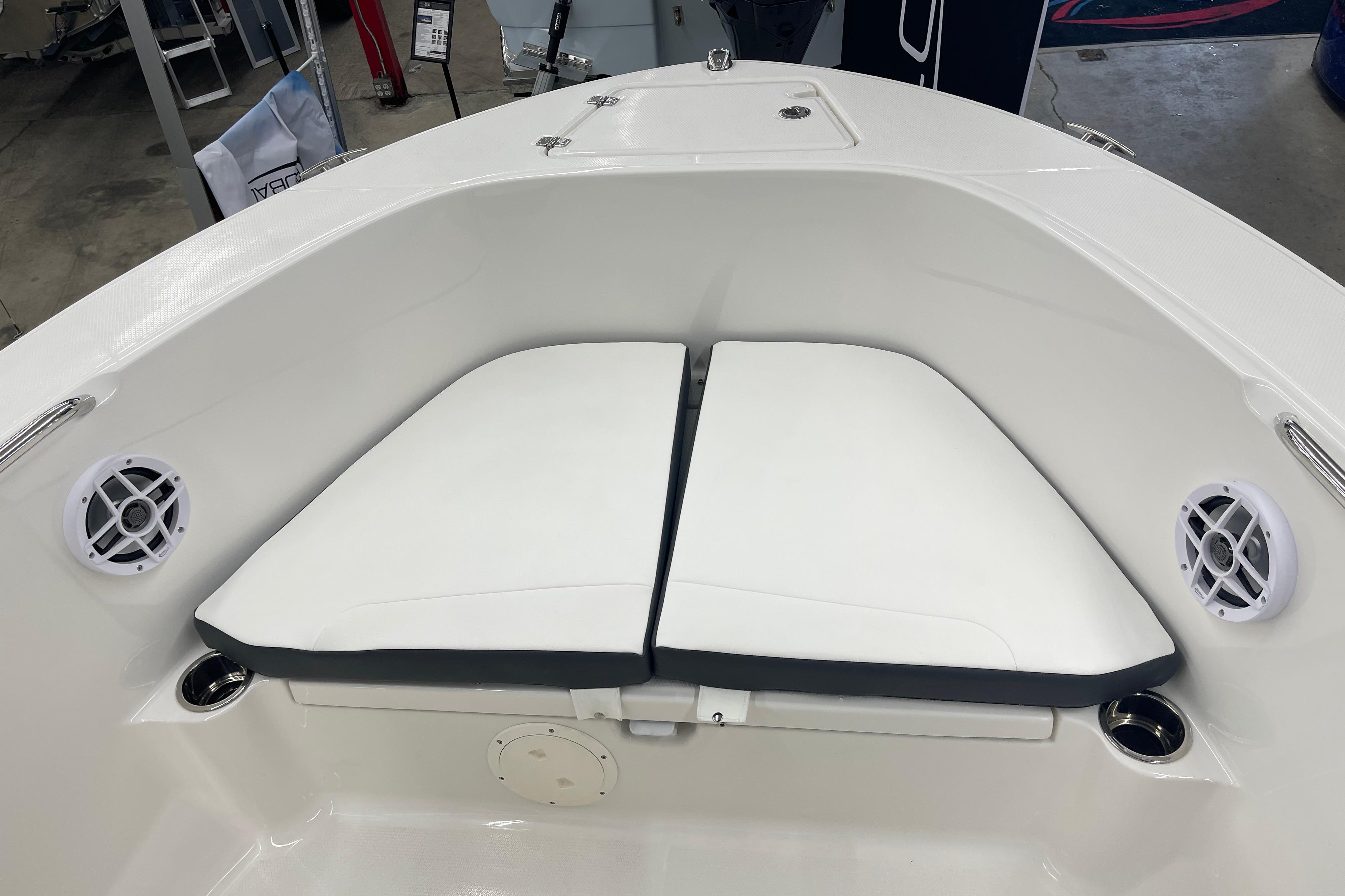 2026 Robalo R180 Center Console boat interior with cushioned seating and speakers.