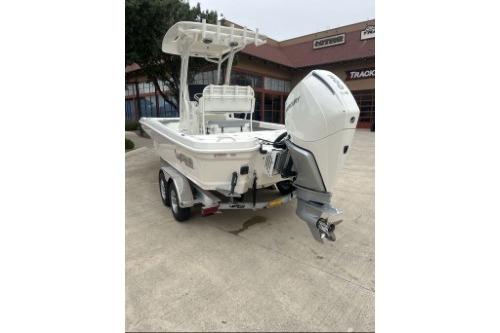2026 Mako 24 APEX boat with outboard motor on trailer, parked outdoors.