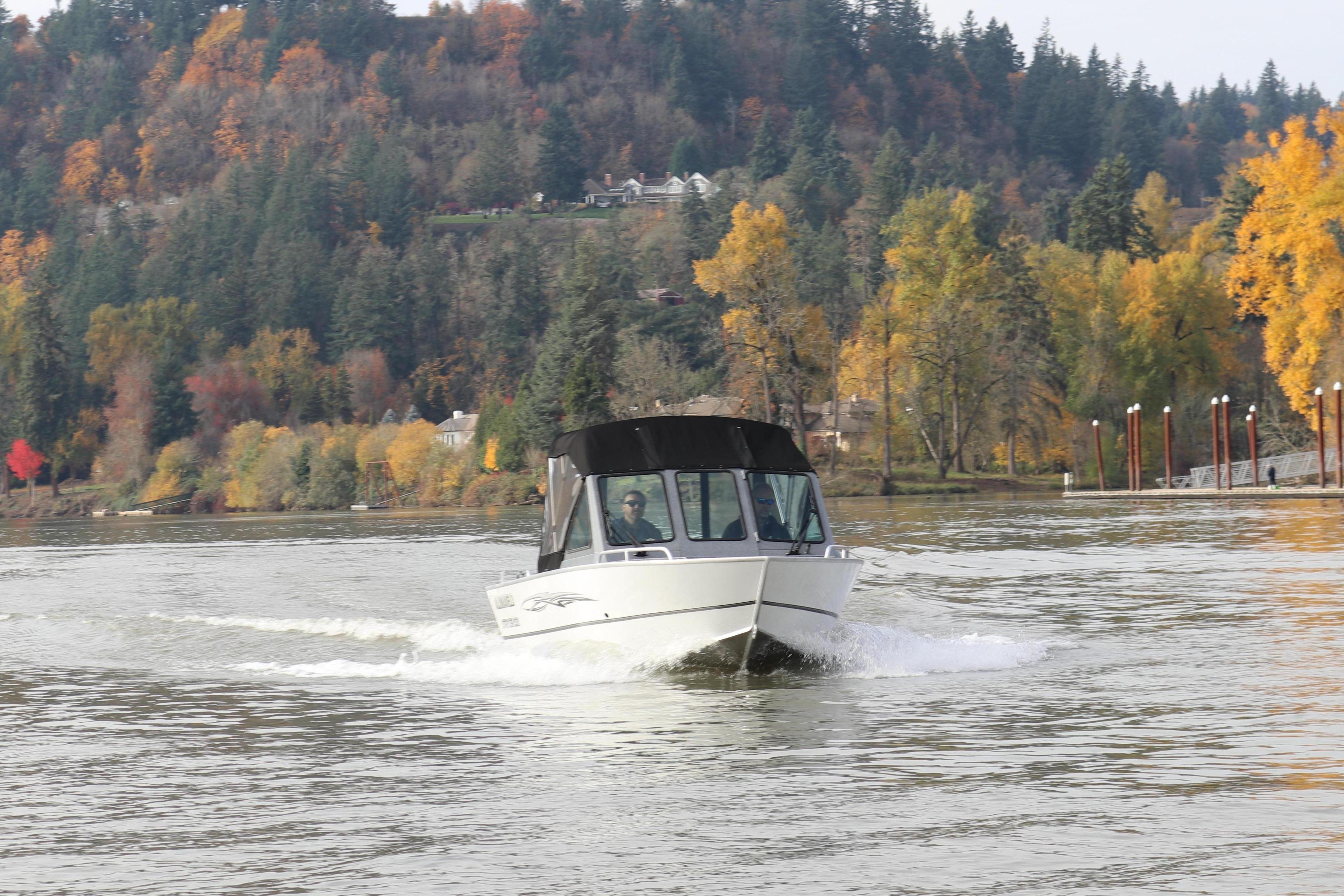 Alumaweld Stryker 2026 on a river with autumn scenery.