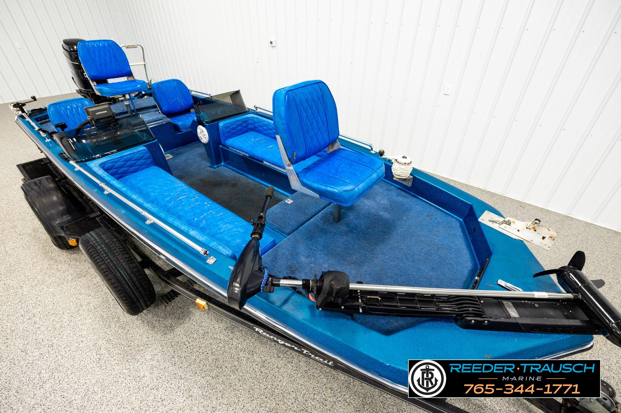 1980 Ranger 175 VS boat with blue seating and trolling motor in showroom.