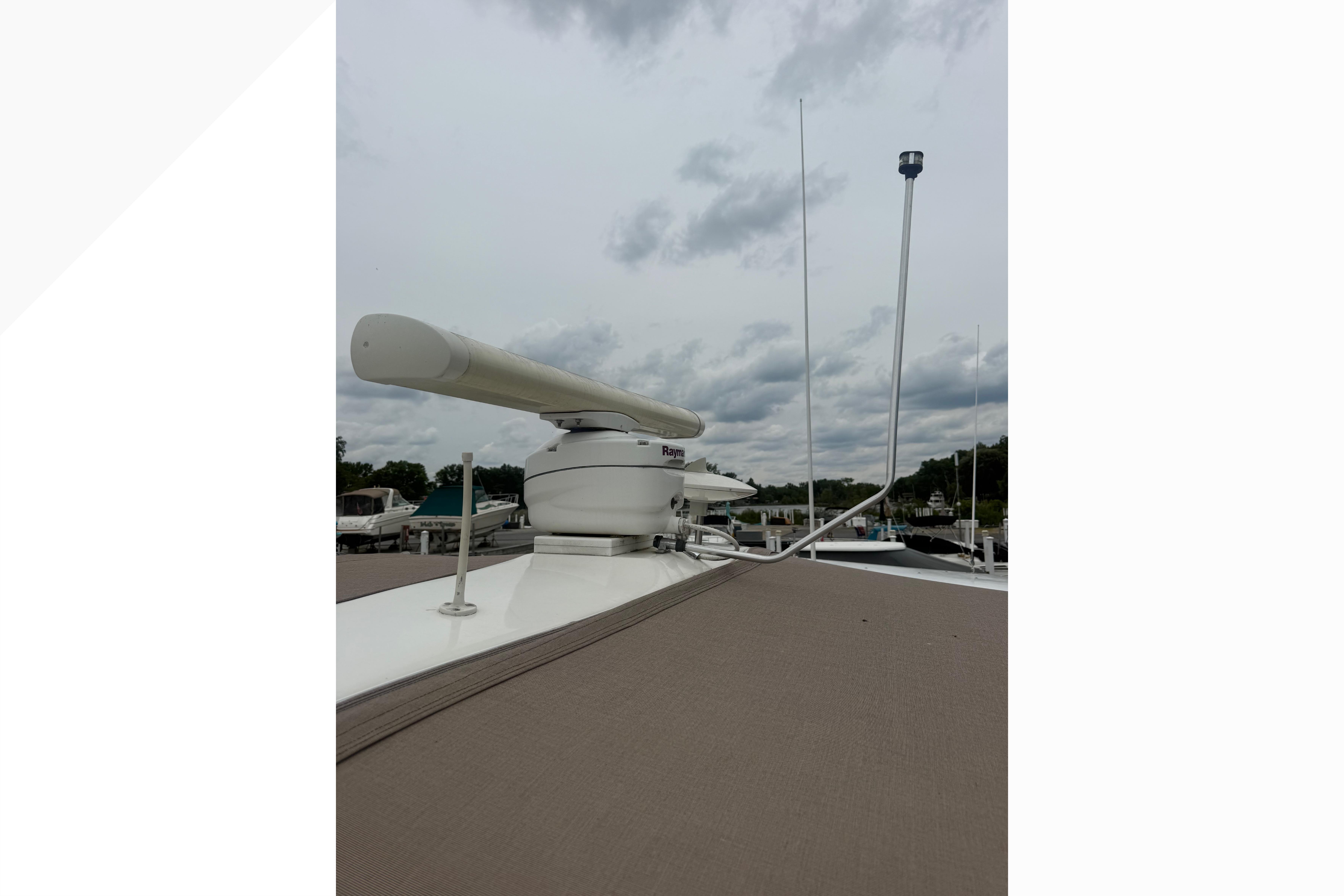 Radar equipment on a 1998 Sea Ray Sundancer 400 yacht under cloudy skies.