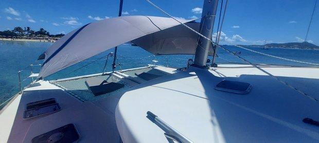 Lagoon 440 catamaran, 2010 model, anchored in clear blue waters under a sunny sky.