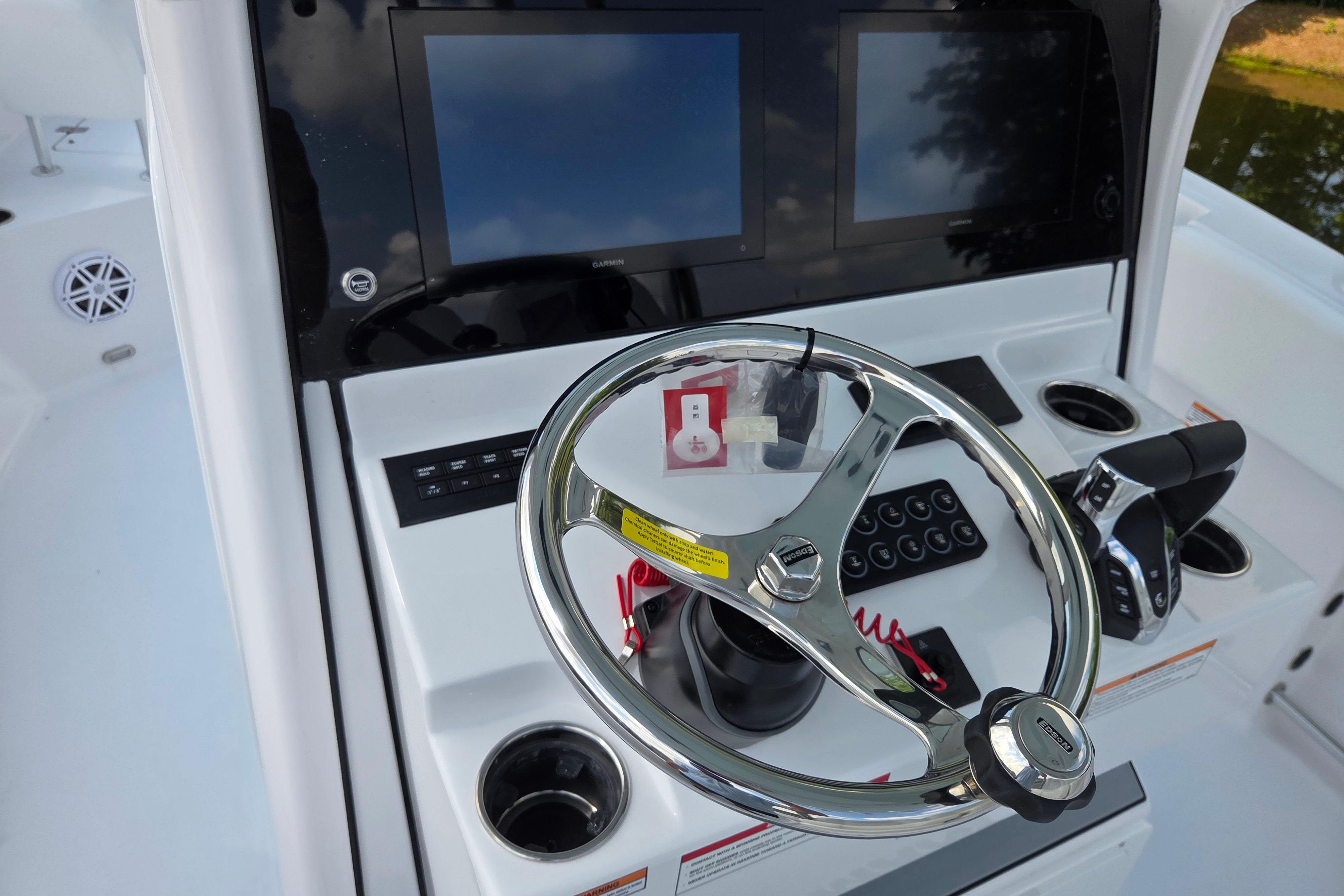 2026 Sportsman Open 252 Center Console helm with dual displays and steering wheel.