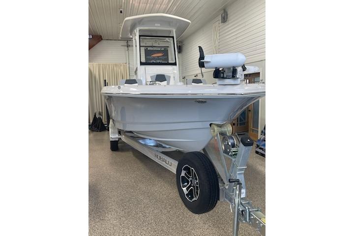 2024 Robalo 246 Cayman boat on trailer in indoor showroom.