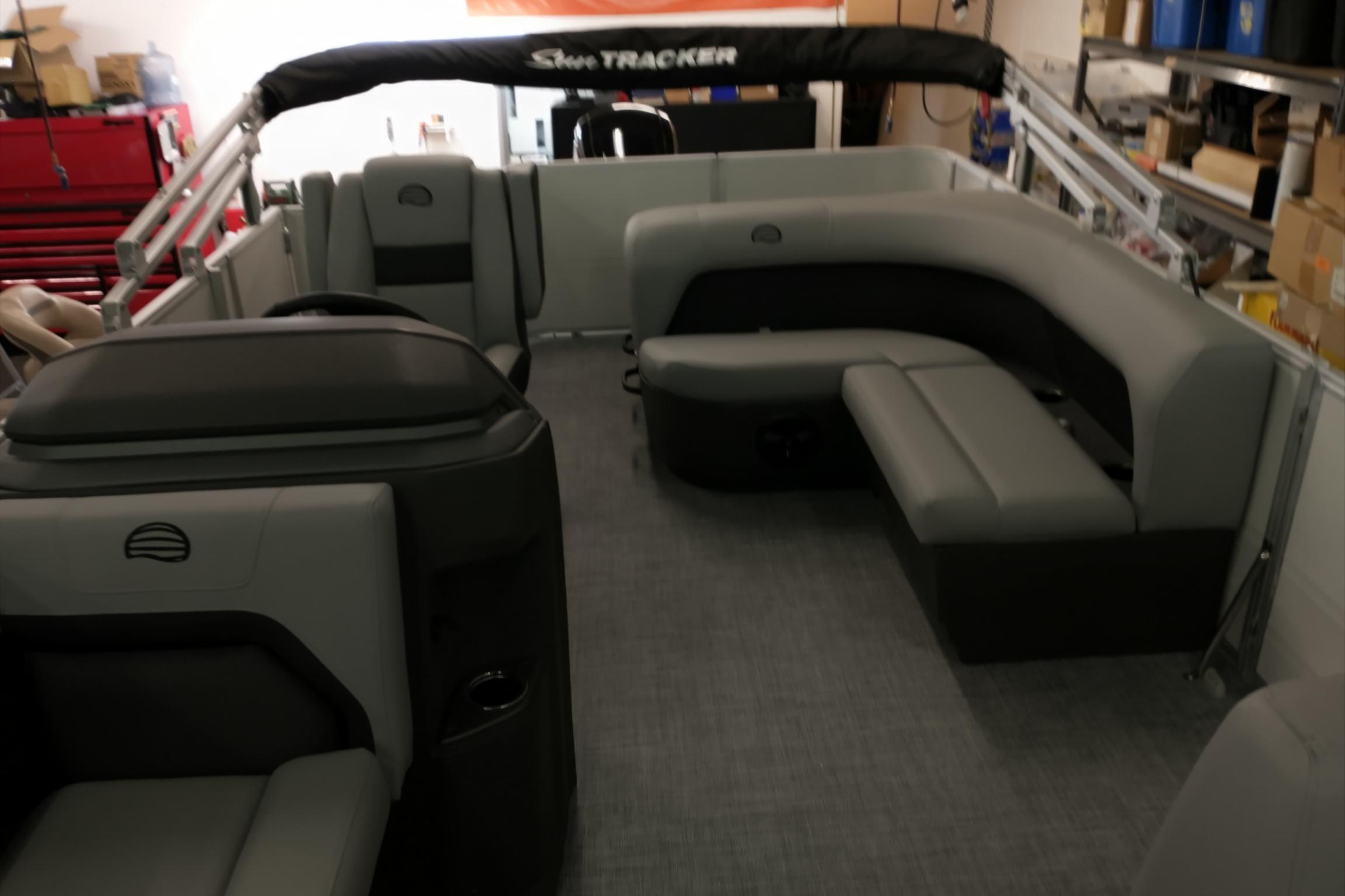 2026 Sun Tracker Party Barge 18 DLX interior with gray seating and spacious layout.