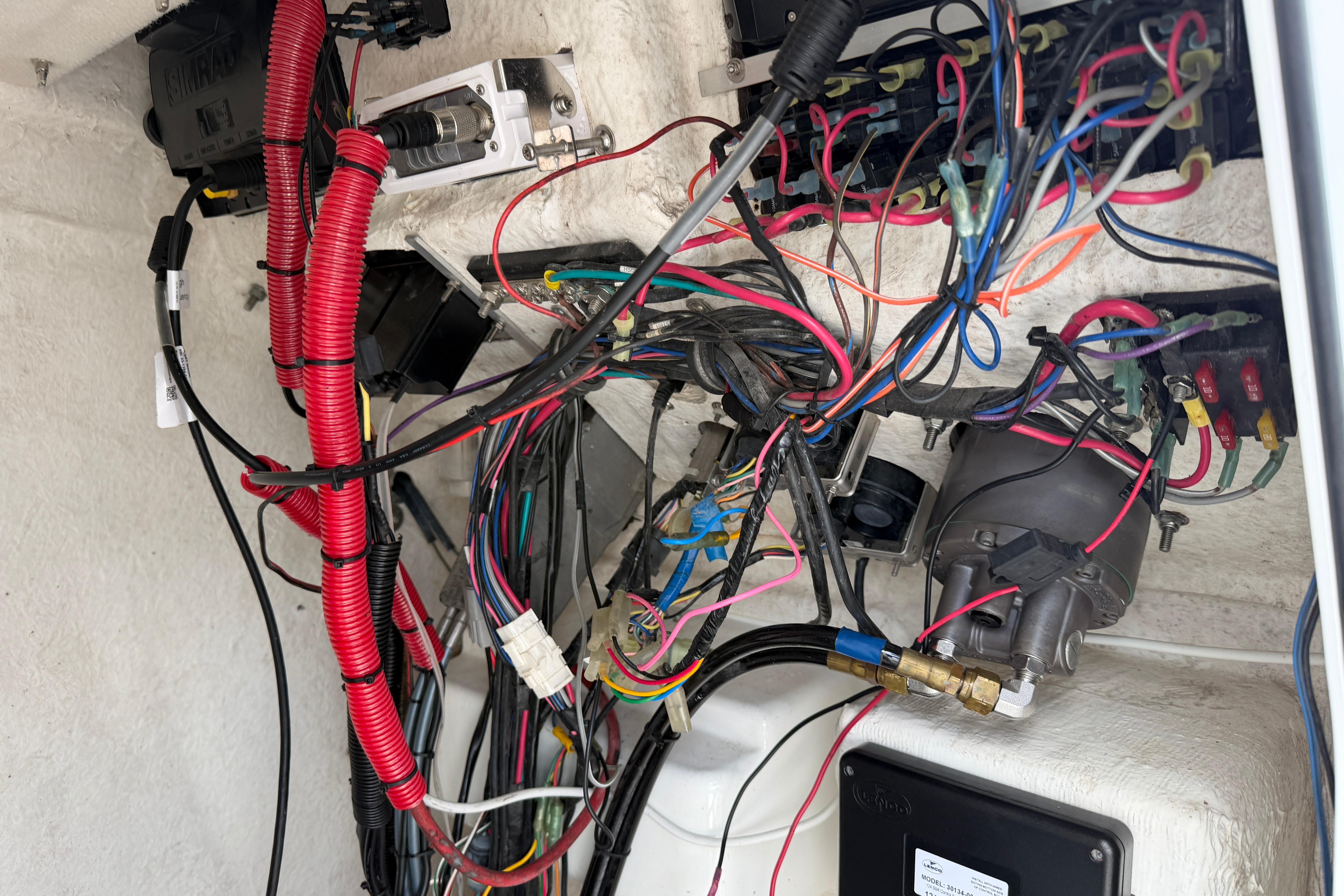Electrical wiring inside a 2015 Sea Hunt Triton 225 boat, showcasing complex connections.