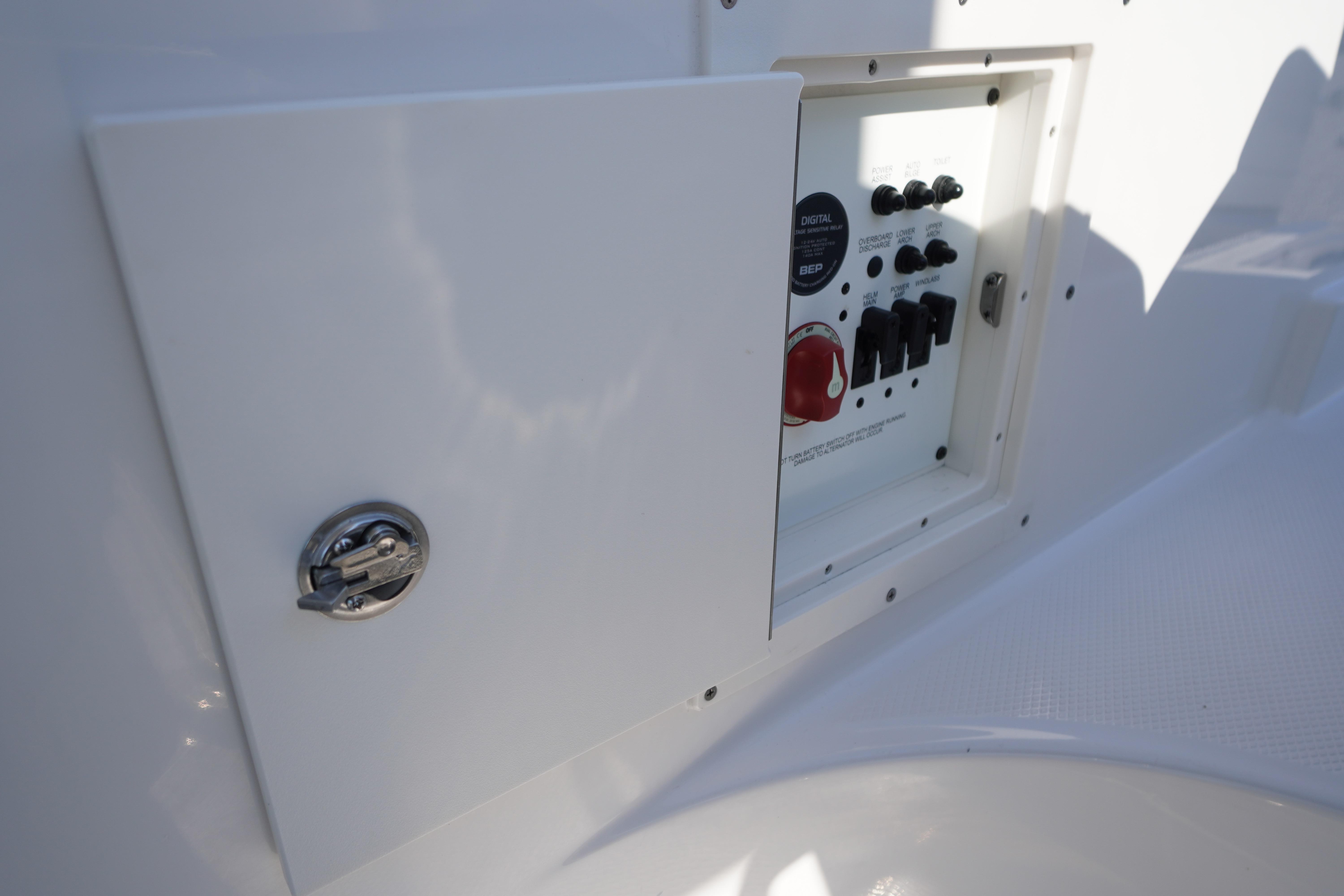 Control panel of 2026 Chaparral 270 OSX boat, featuring switches and a latch.