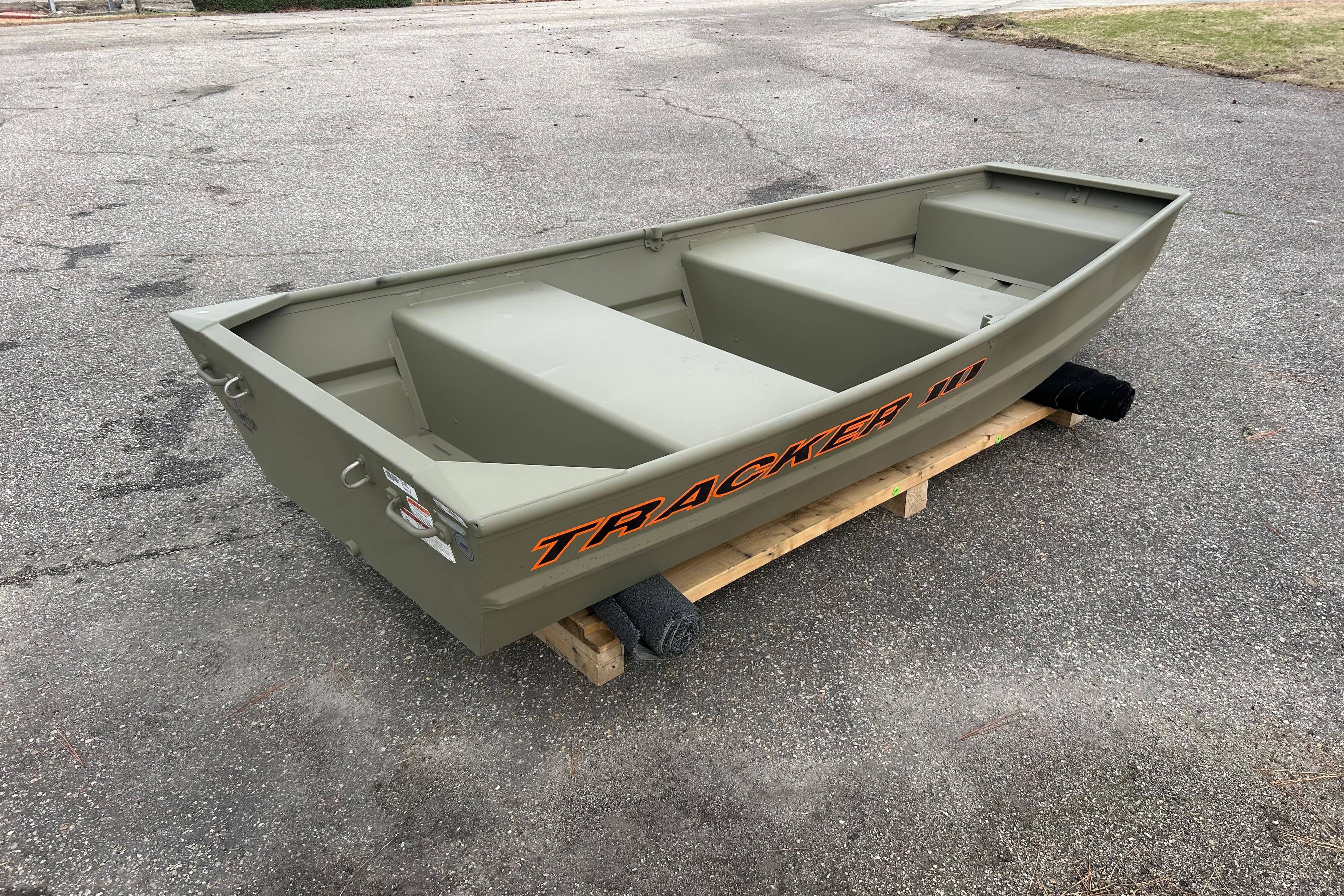 2026 Tracker Grizzly 10 Jon boat on wooden pallet, outdoor setting.