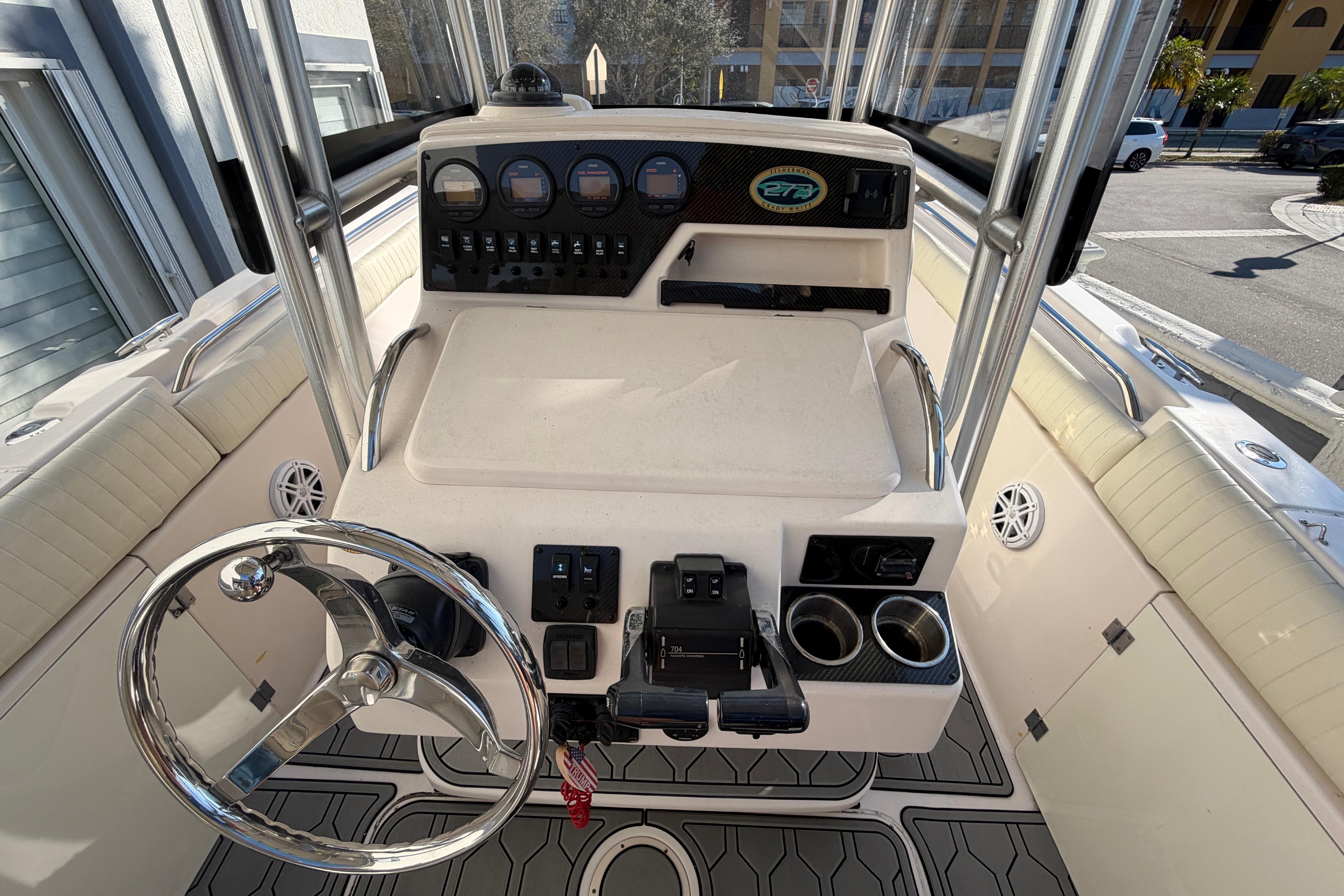 2004 Grady White 273 boat dashboard with steering wheel and control panel.