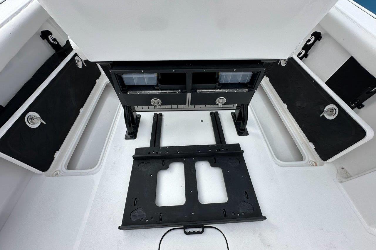 2026 Tidewater 272 LXF boat interior with storage compartments and seating area.