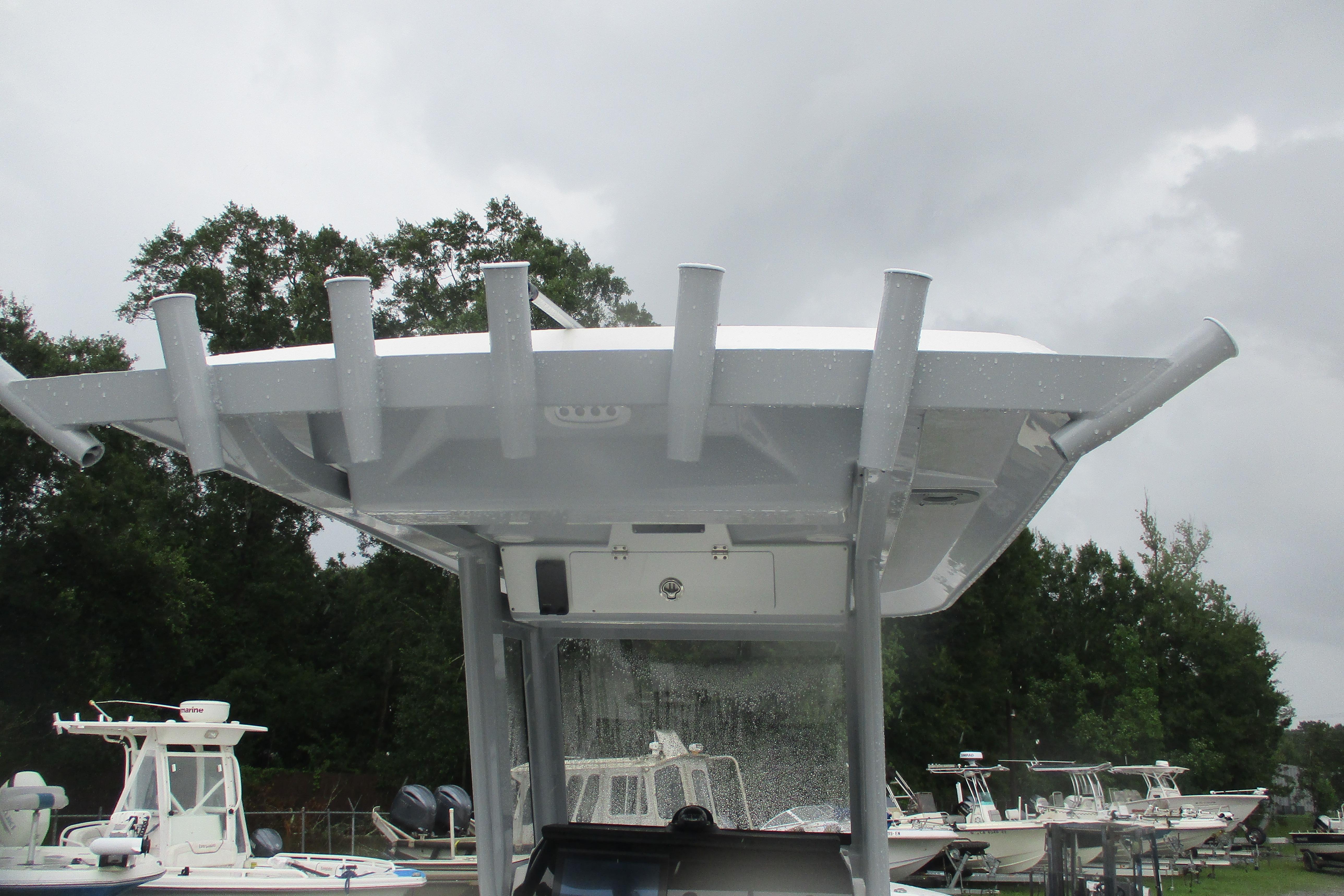 2026 Sea Fox 248 Commander boat with T-top, viewed from below, against cloudy sky.