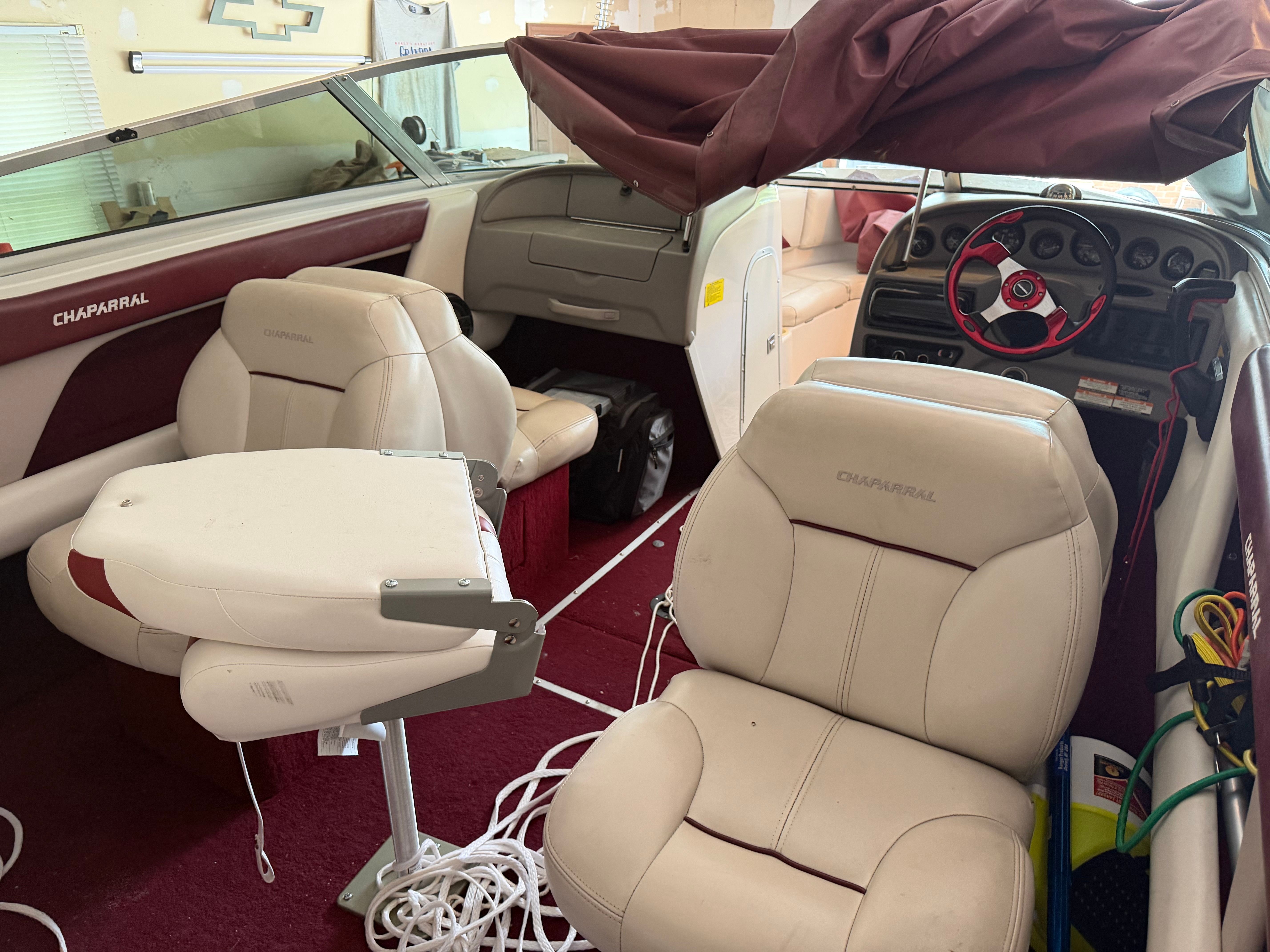 Interior of a 1994 Chaparral 1930 boat with beige seats and red carpet.