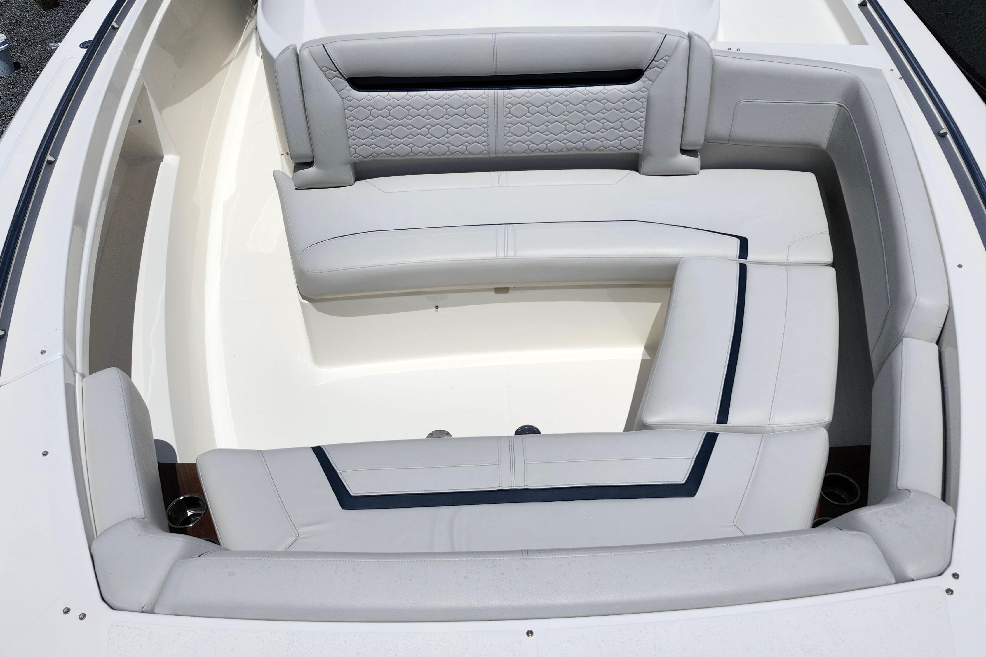 Luxurious seating area on 2022 Tiara Yachts 38 LS, featuring elegant white upholstery.