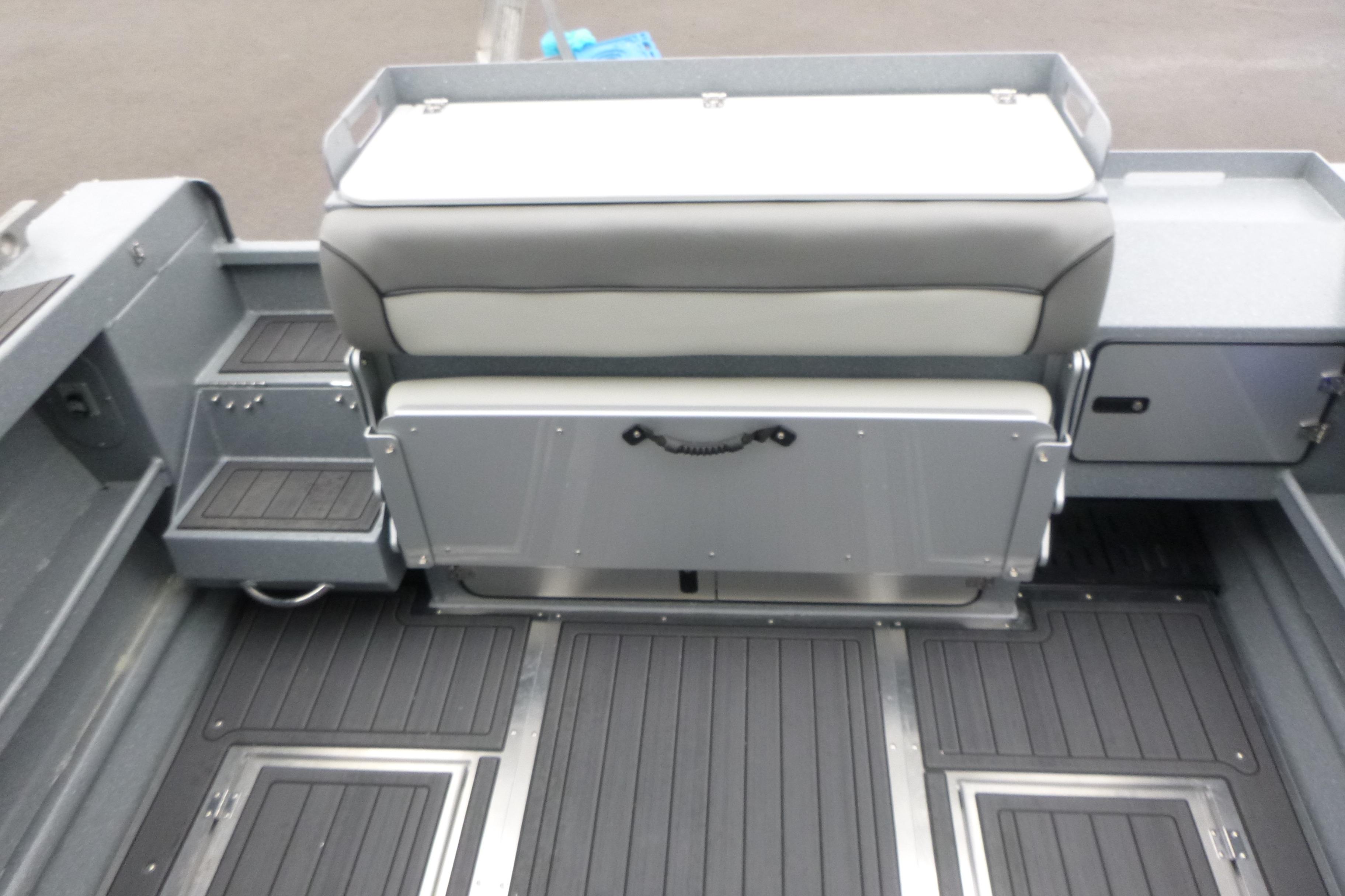 2026 KingFisher 25 XAC boat interior with seating and storage compartments.