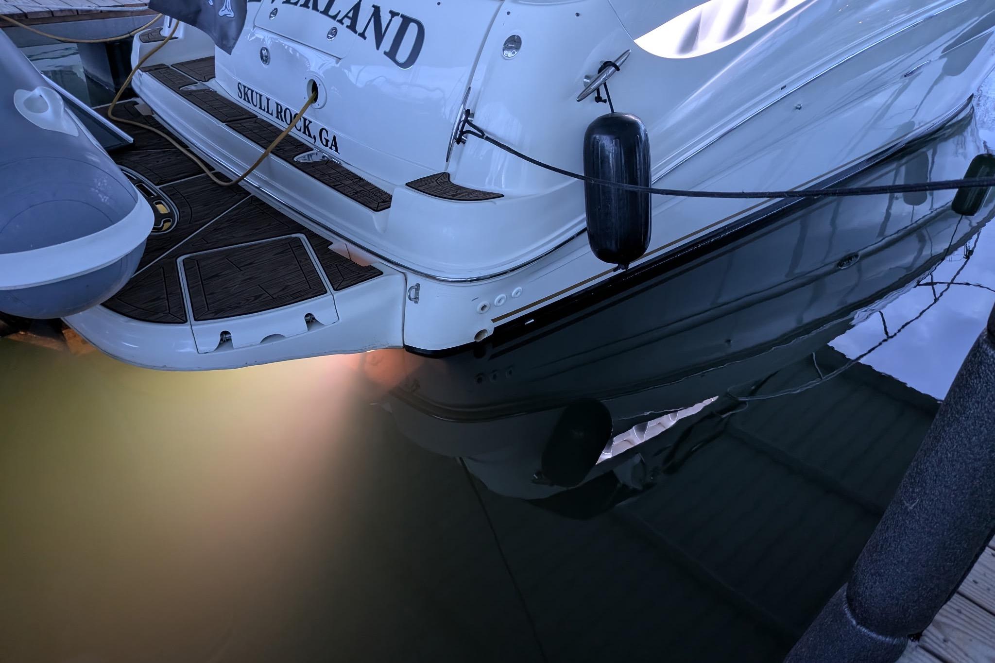 2002 Sea Ray Sundancer 320 docked, rear view with underwater lighting, Skull Rock, GA.