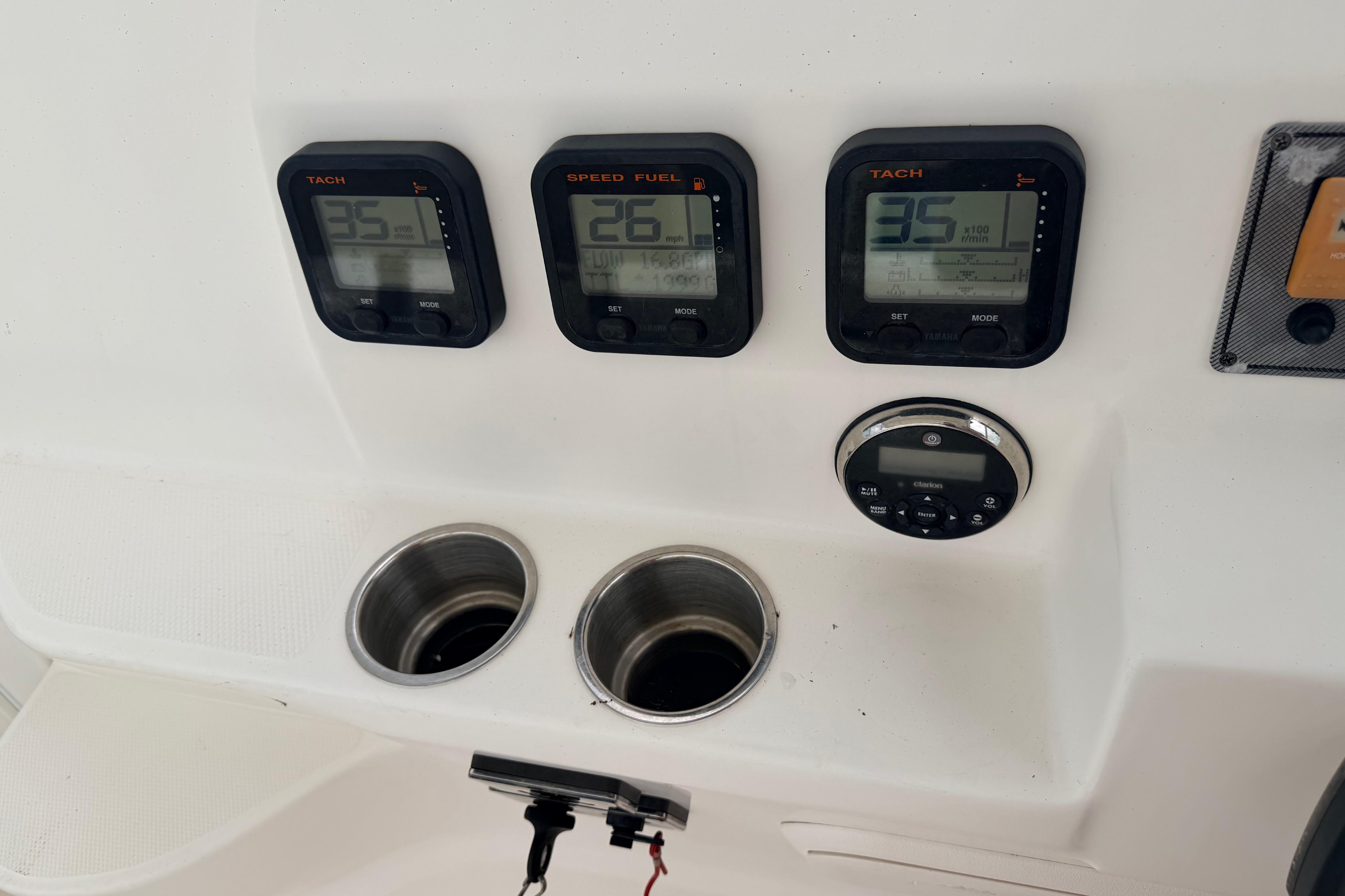 Dashboard of a 2015 Wellcraft 290 Coastal boat with tachometers and speed fuel gauges.