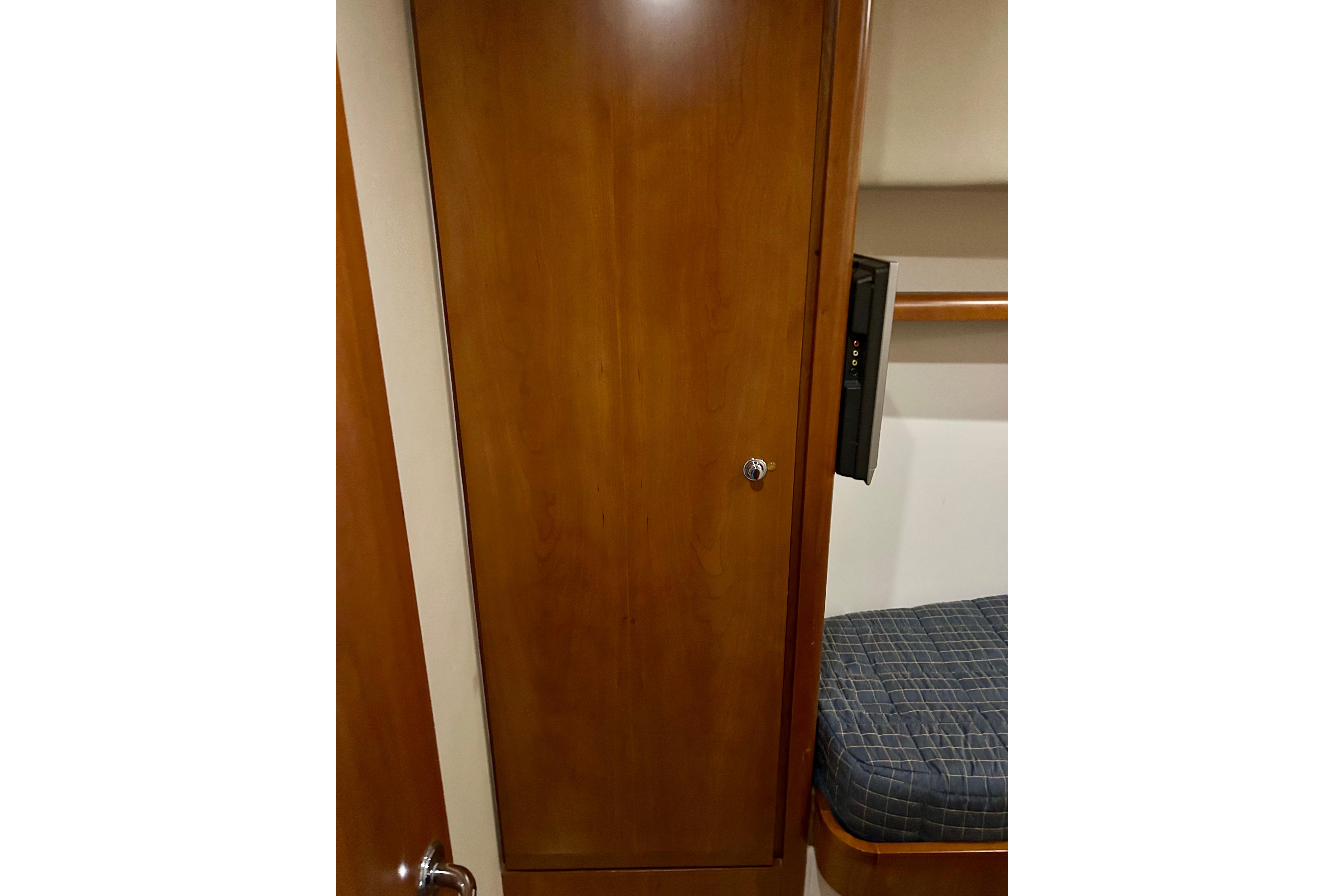 Interior of 2005 Bertram 390 Convertible with wooden cabinet and cushioned seating.
