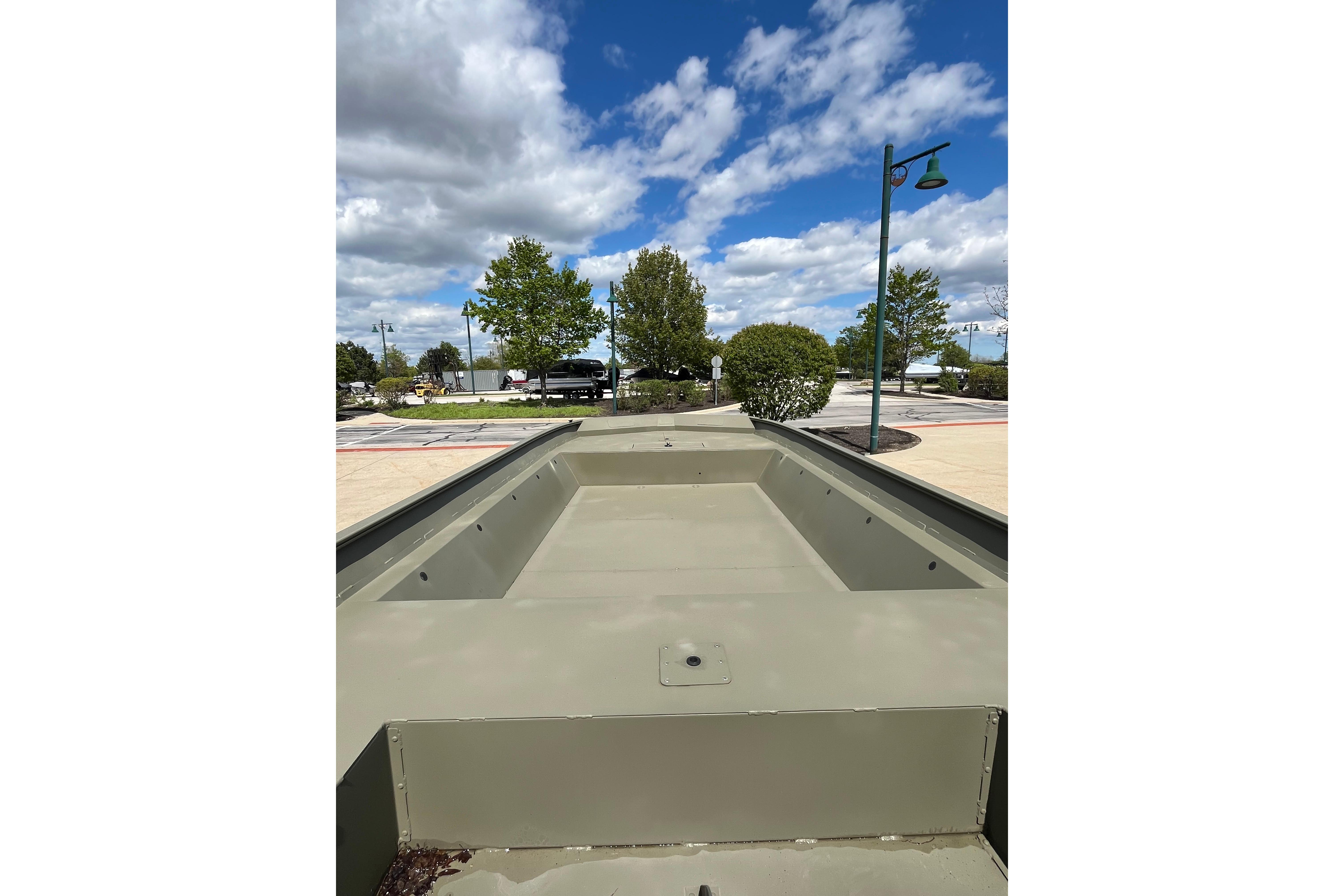 2026 Tracker Grizzly 2072 Utility boat on display under a partly cloudy sky.