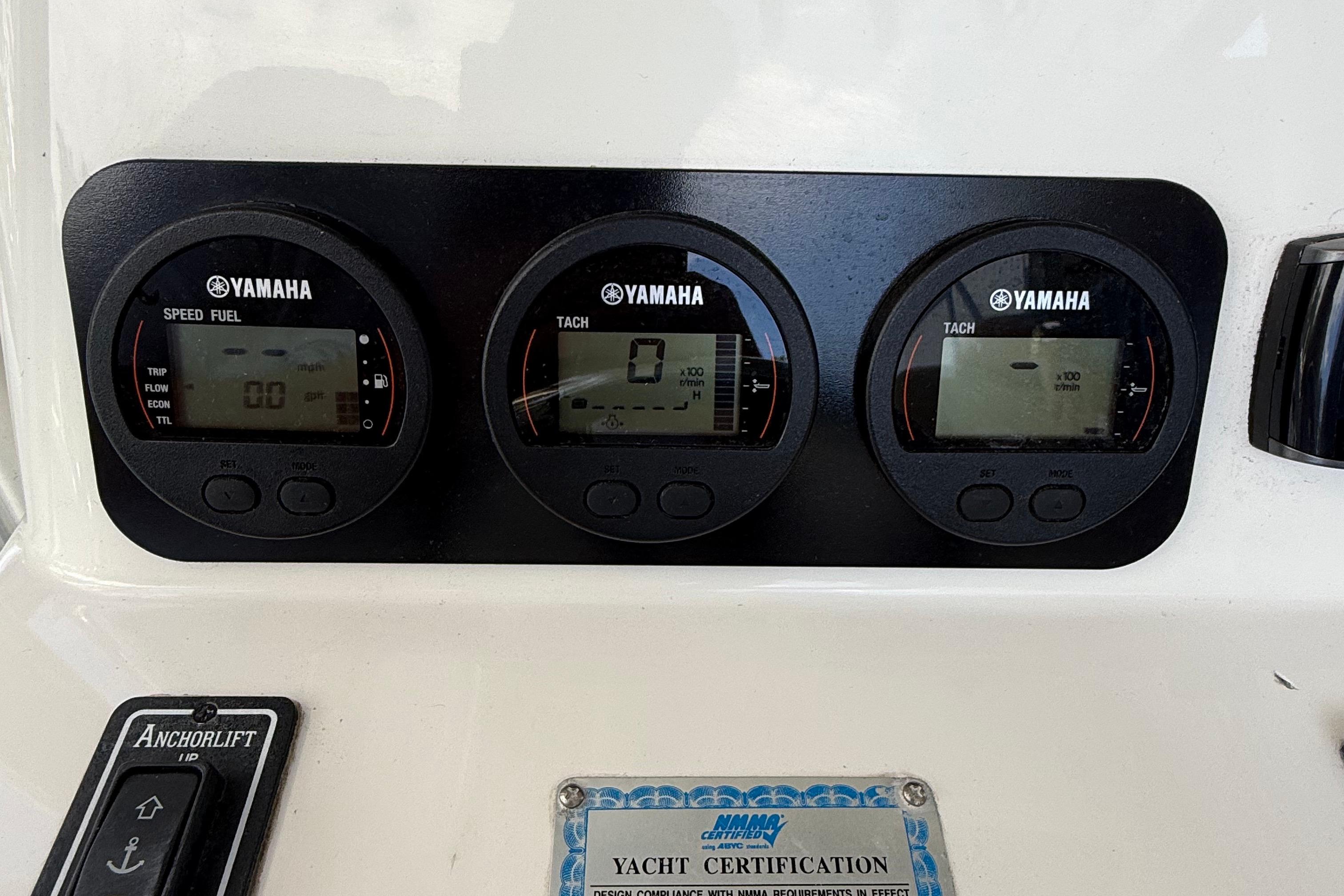 Yamaha gauges on 2008 Century 2901 Center Console boat dashboard with anchor lift control.