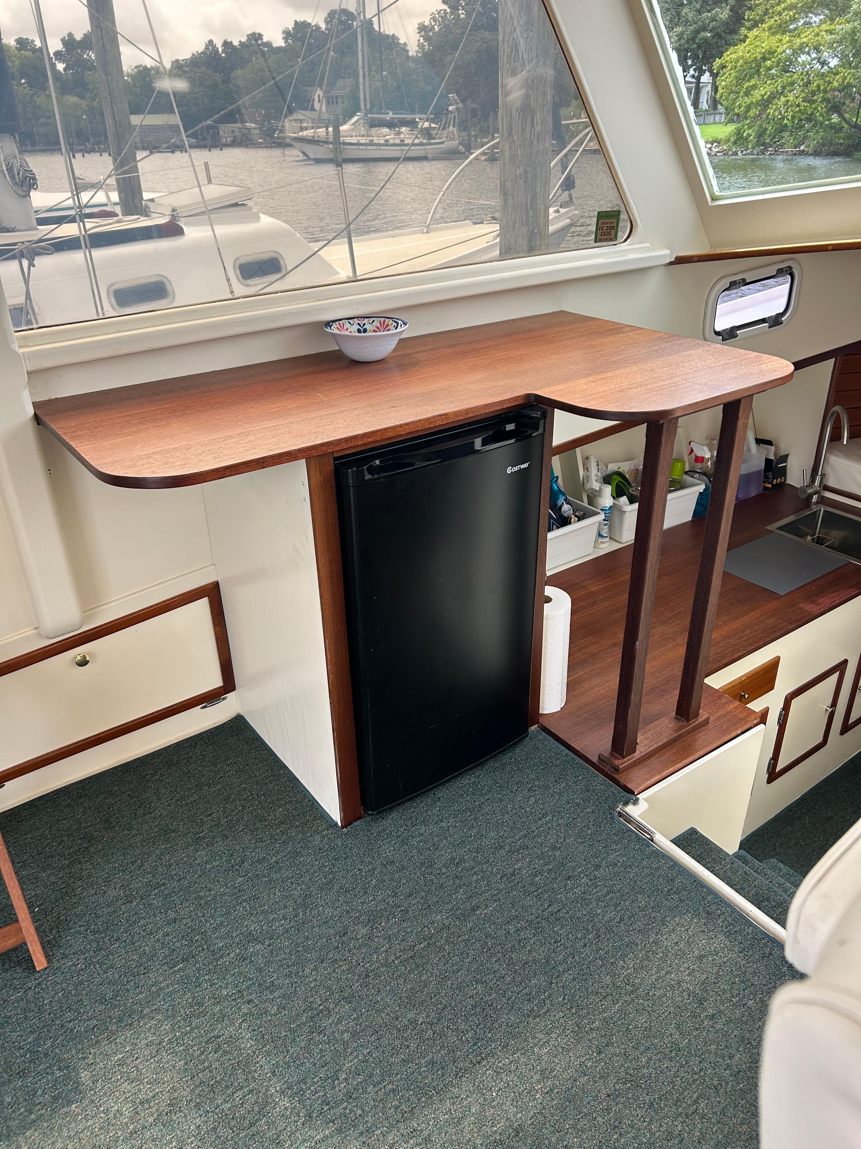 Interior of 1996 Mast & Mallet 34 Rabbit Custom boat with wooden counter and mini fridge.