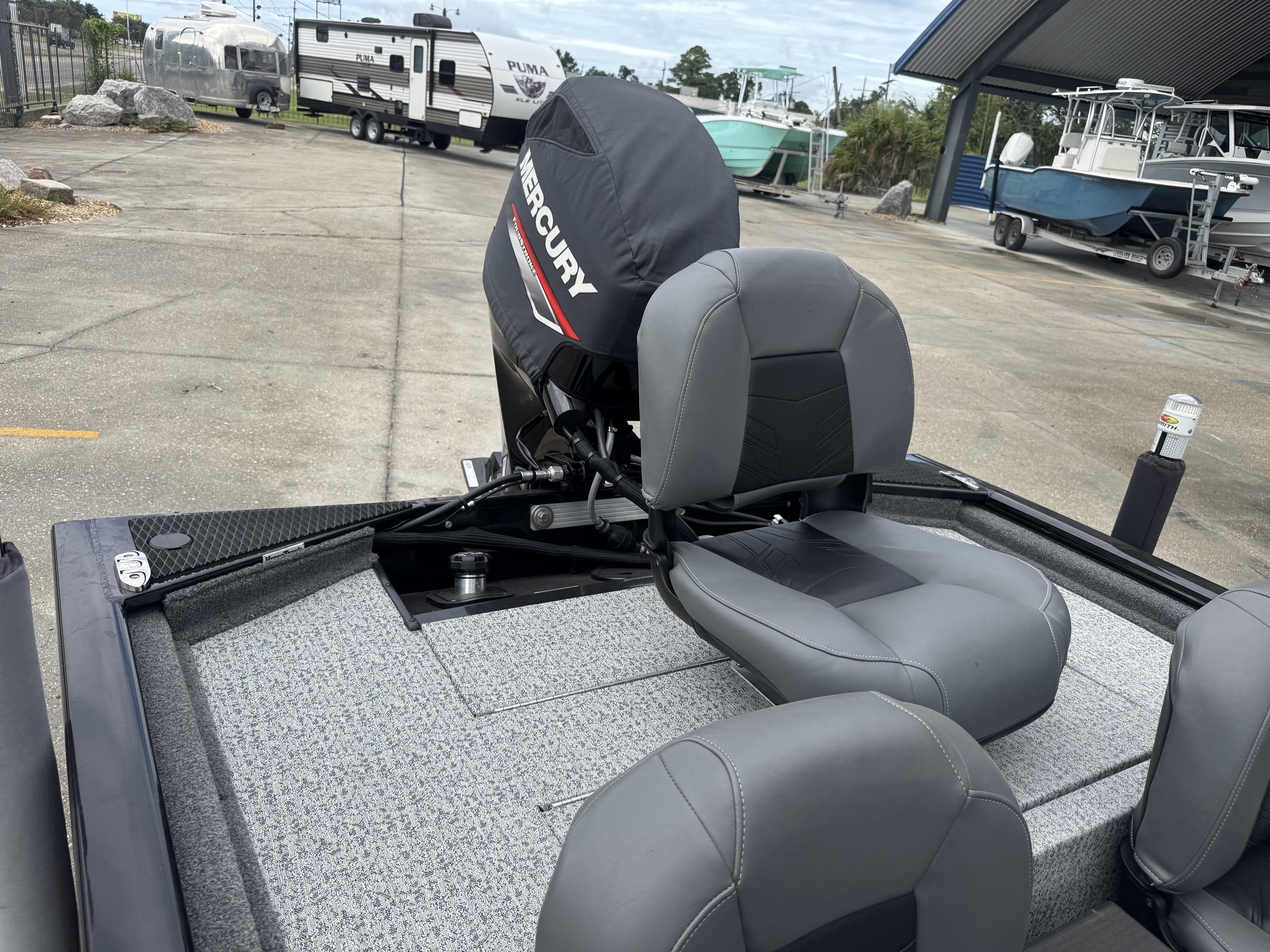 2024 Tracker Pro 170 boat with Mercury engine, featuring gray seating and carpeted deck.