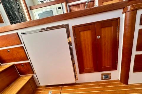Interior of 2006 Lyman-Morse 38 Jet Boat with wooden cabinetry and modern appliances.