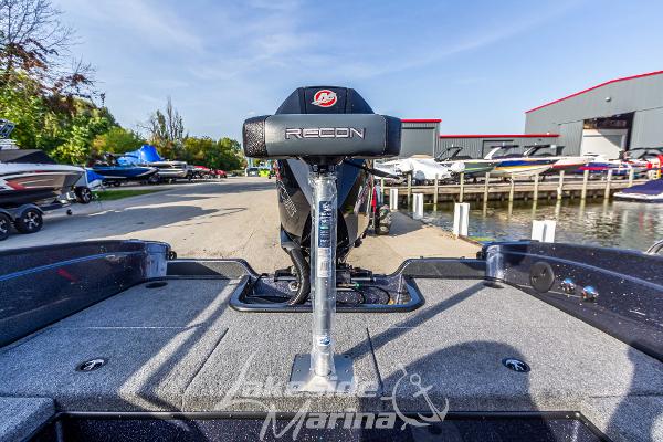 2024 Recon 985 SC fishing boat at lakeside marina.