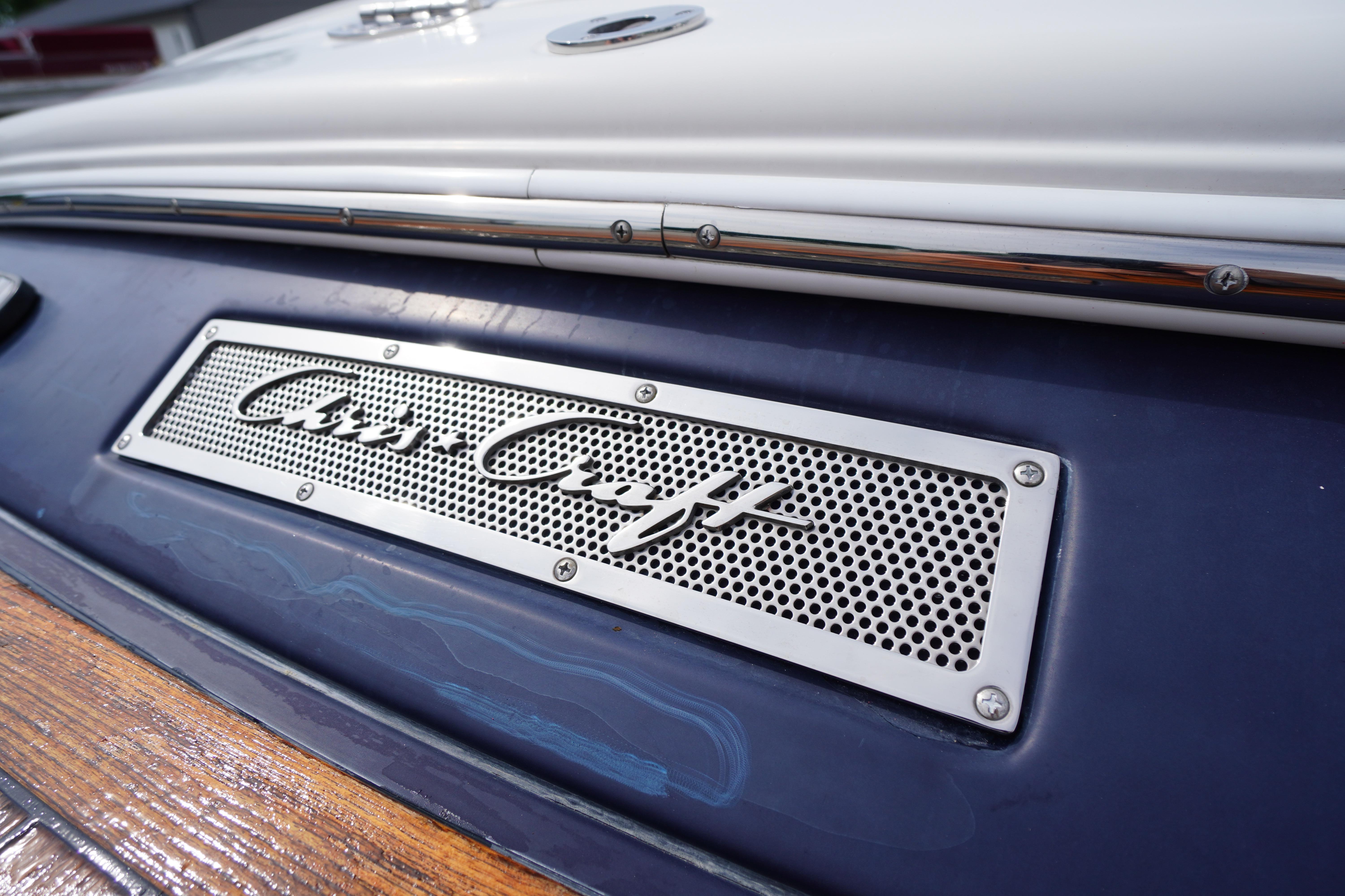 Close-up of 2005 Chris Craft Speedster Heritage boat logo on blue hull.