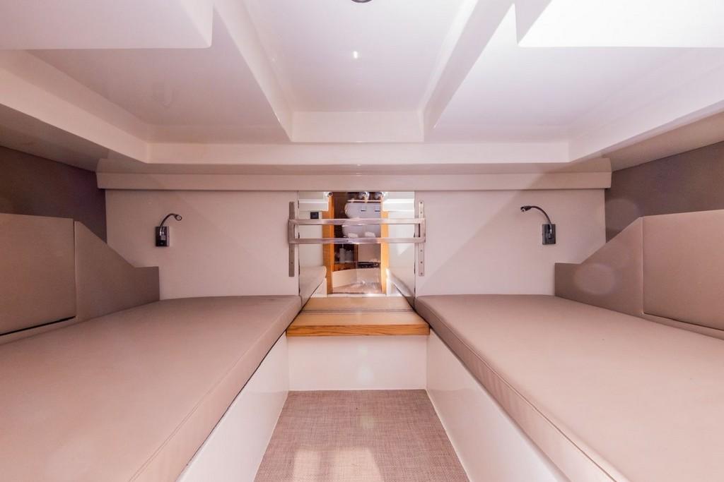Interior cabin of 2018 De Antonio Yachts D 33 Open, featuring twin beige cushioned benches.