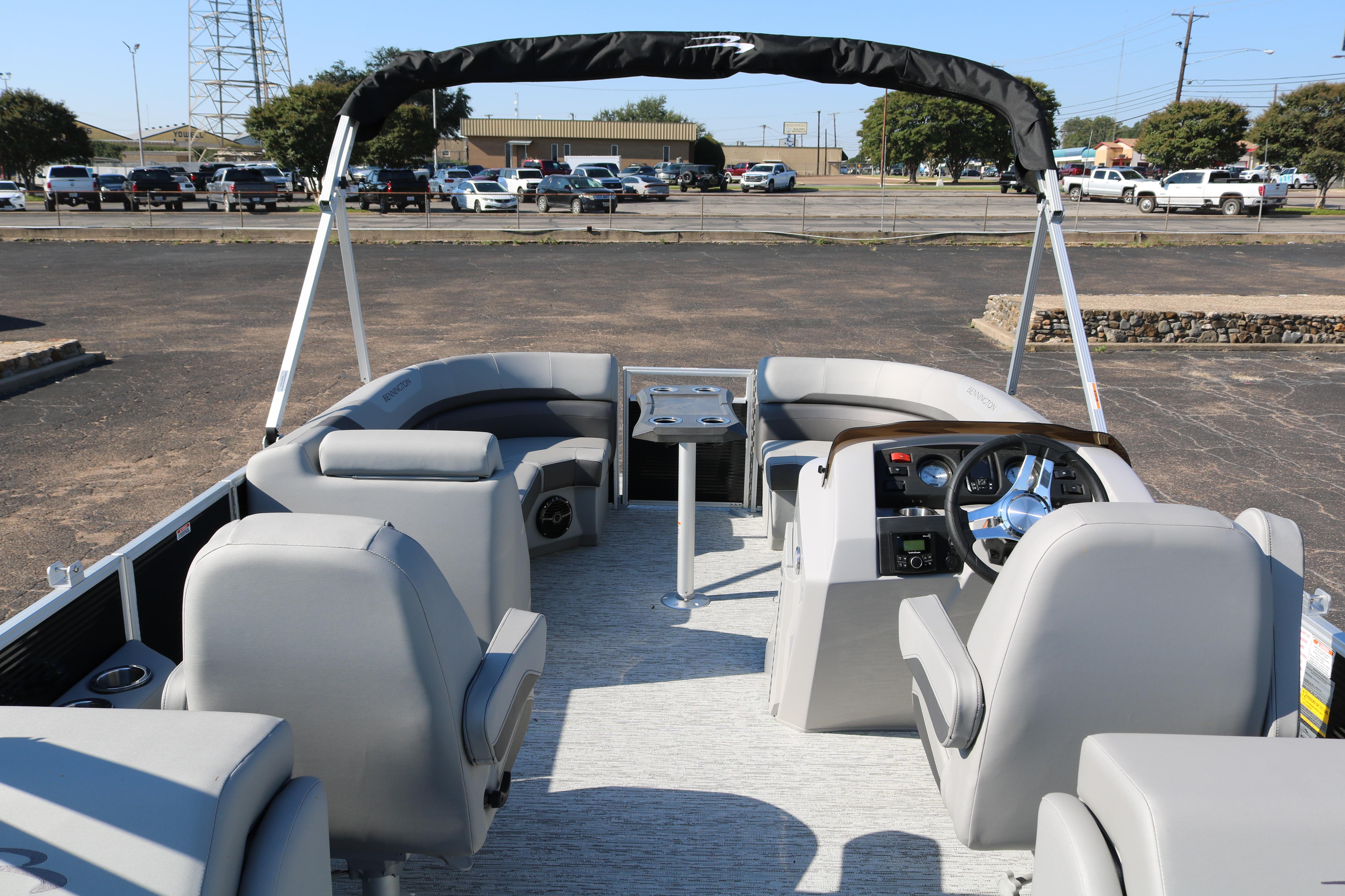 2026 Bennington 22SX Stern Radius pontoon boat interior with seating and steering console.